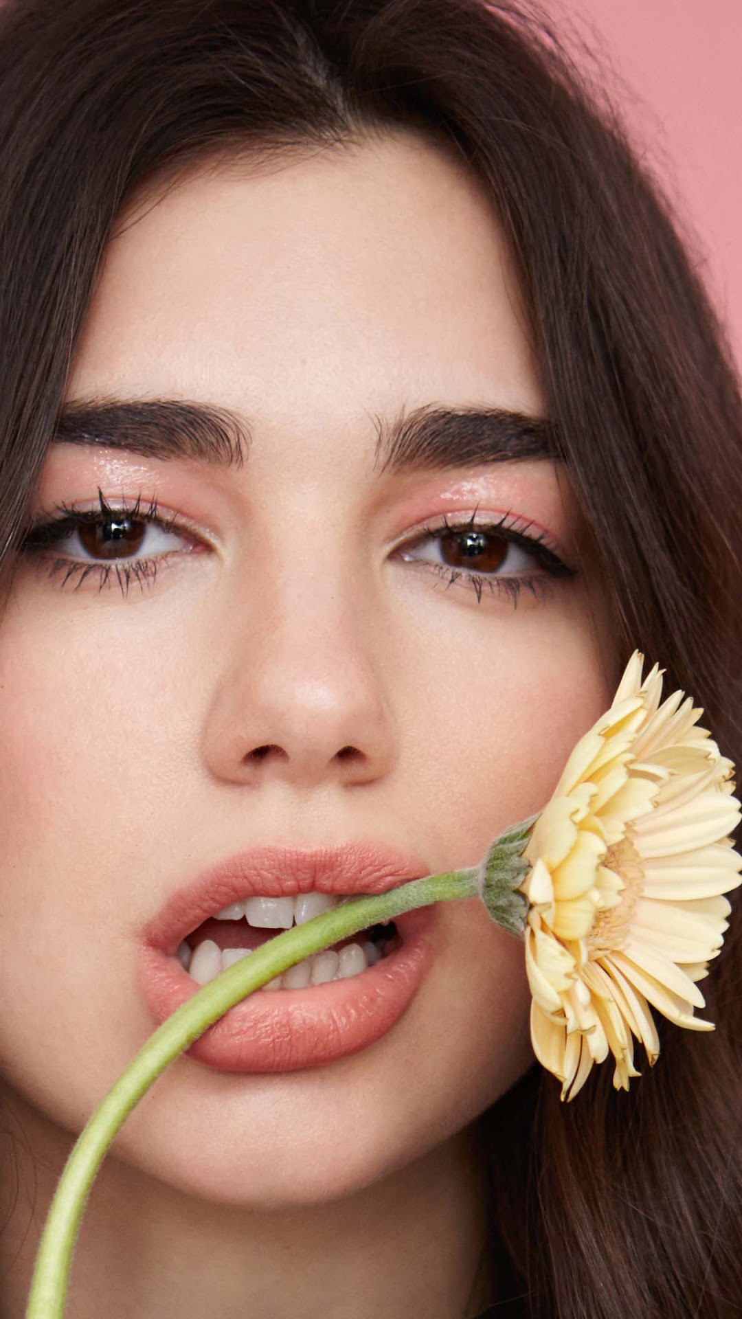 Dua Lipa with a yellow flower HD Phone Wallpaper