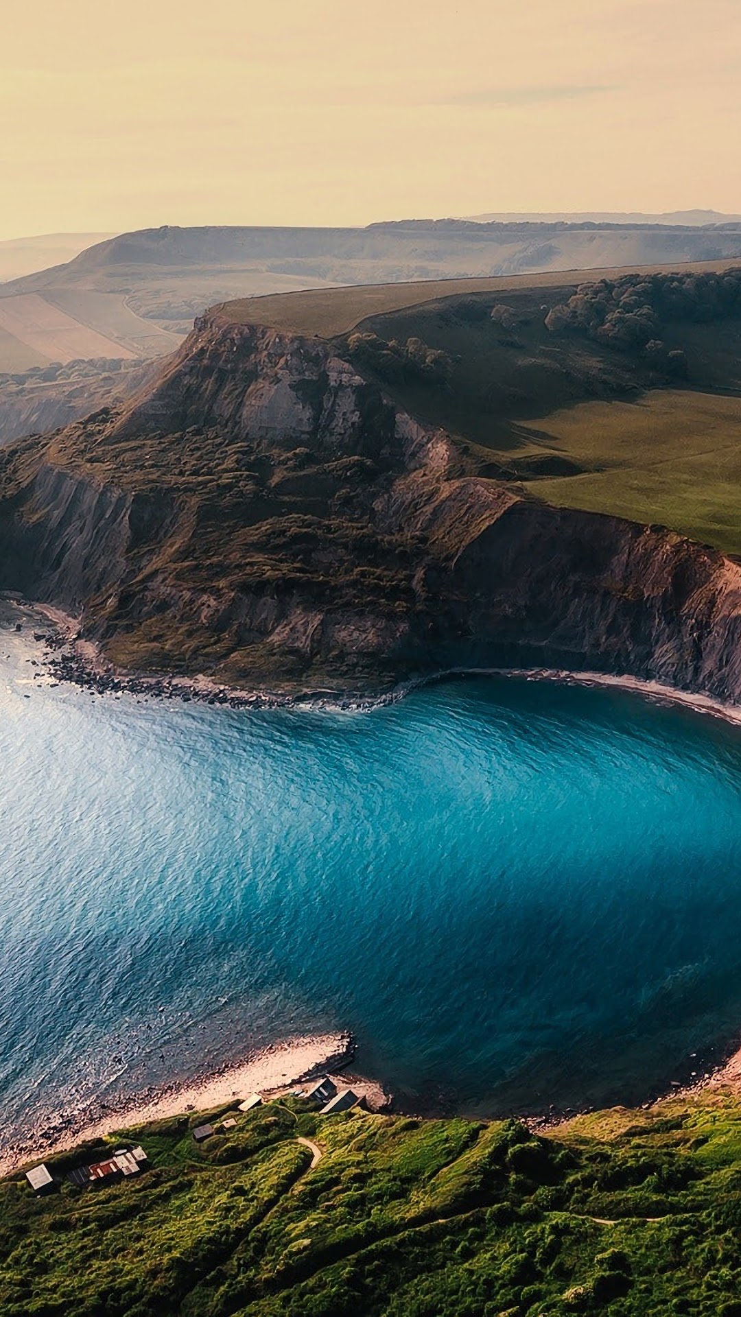 Coastal cliffs overlooking a turquoise bay HD Phone Wallpaper