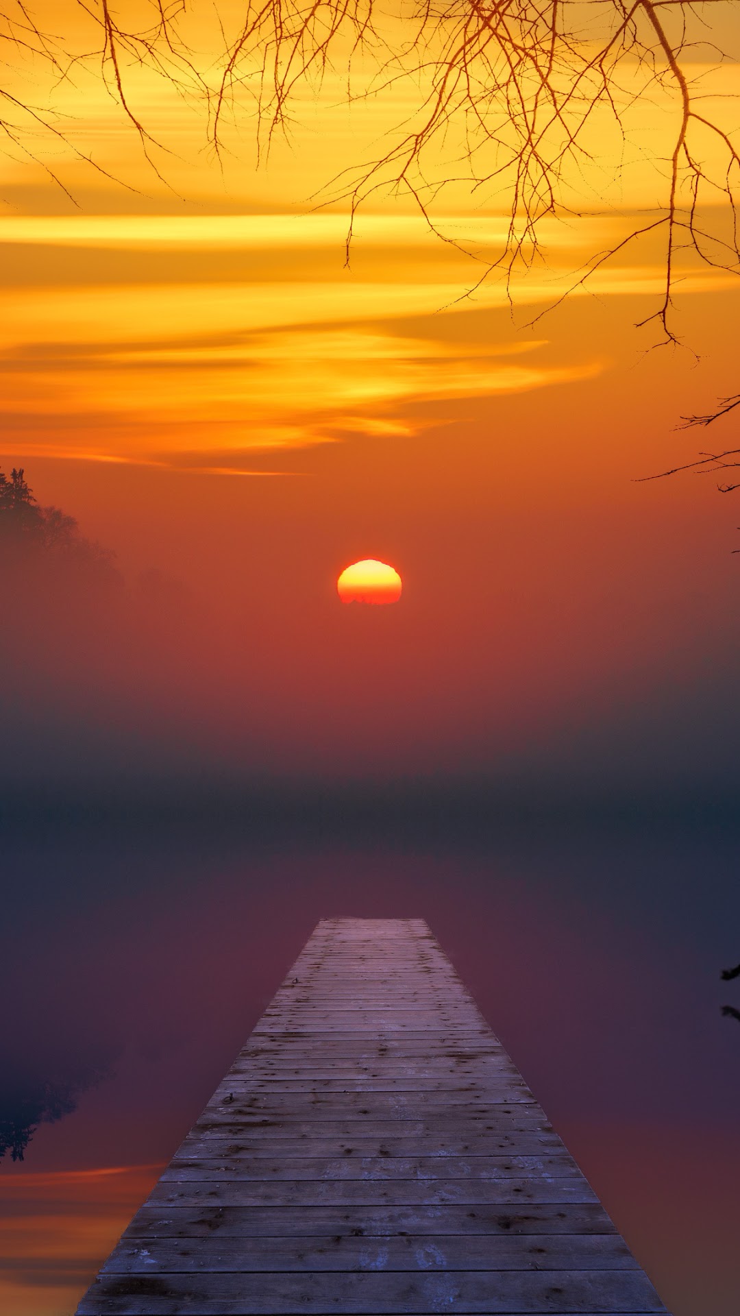 Sunset over a misty lake with a wooden pier HD Phone Wallpaper