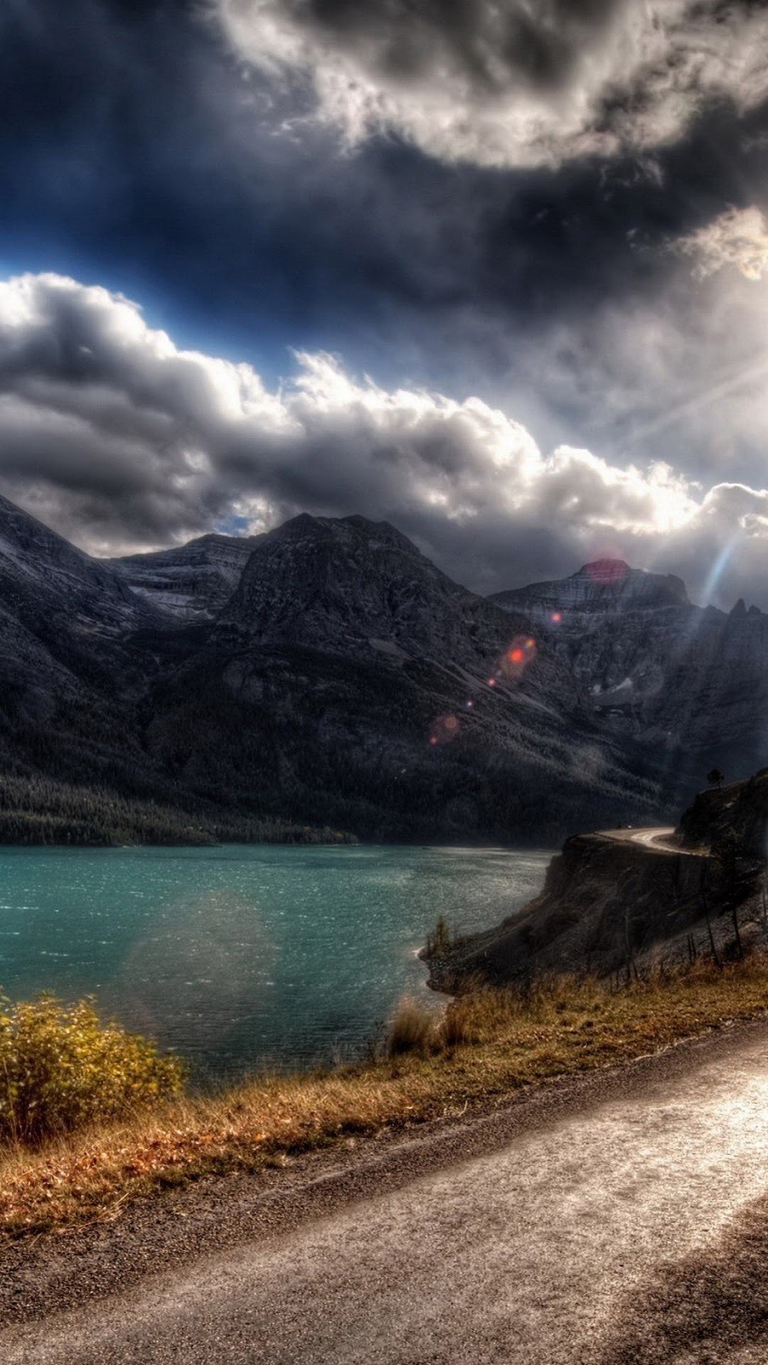 Mountains and a lake under a dramatic sky HD Phone Wallpaper
