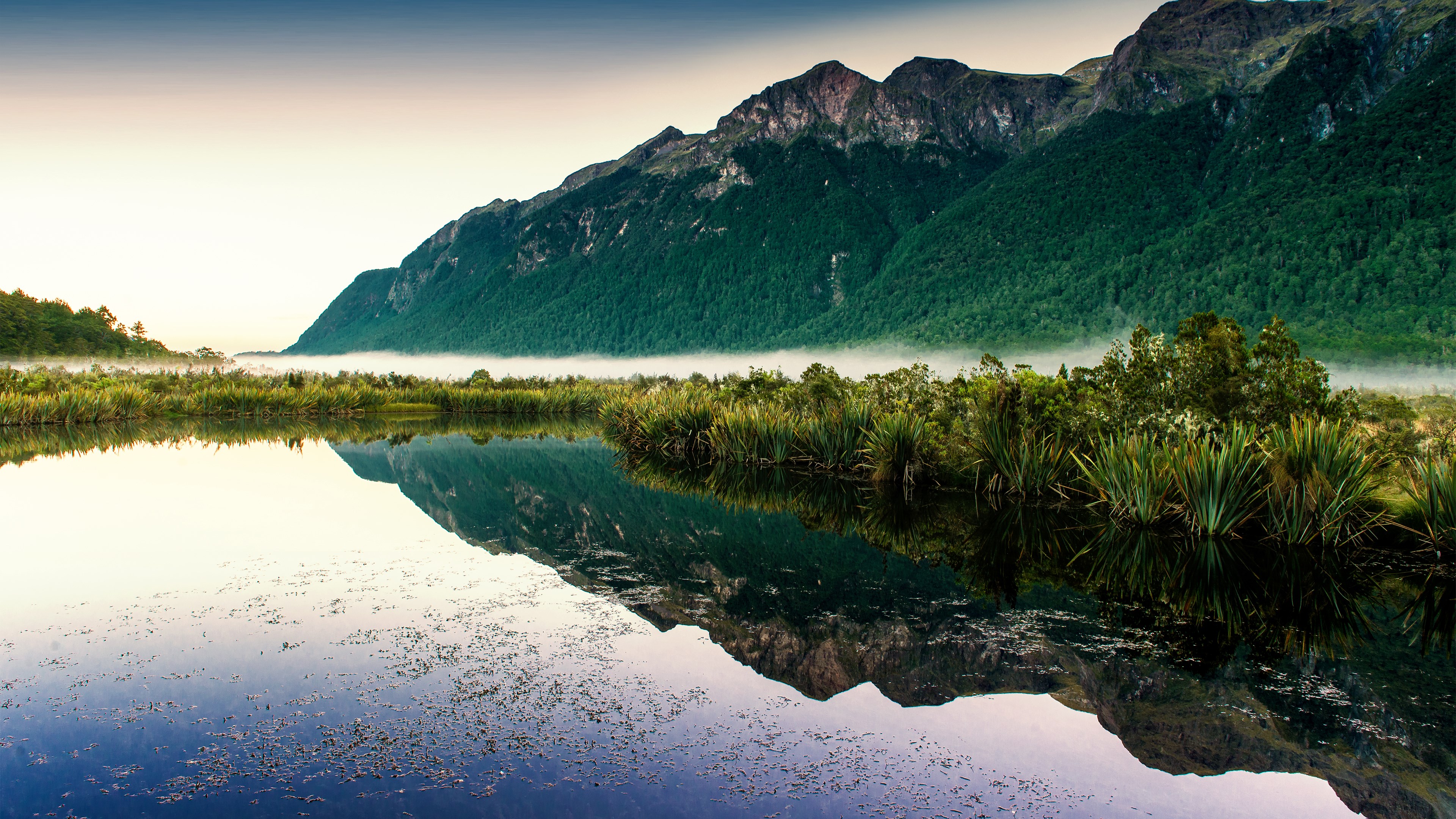 Mountain reflection in a calm lake with mist HD Wallpaper