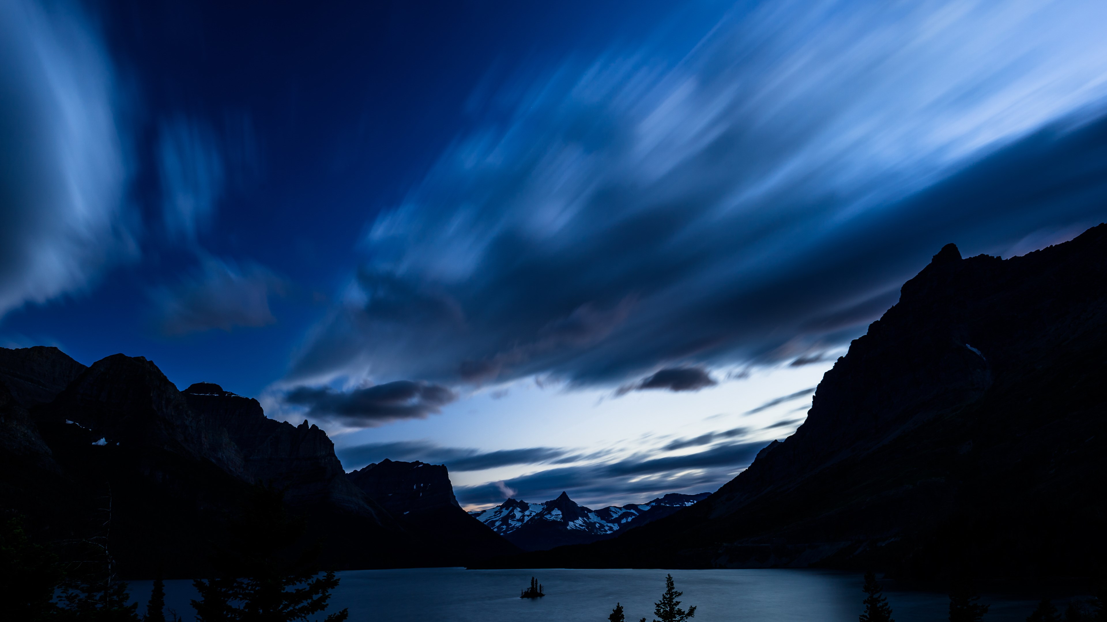 Long exposure of clouds over mountains and lake HD Wallpaper