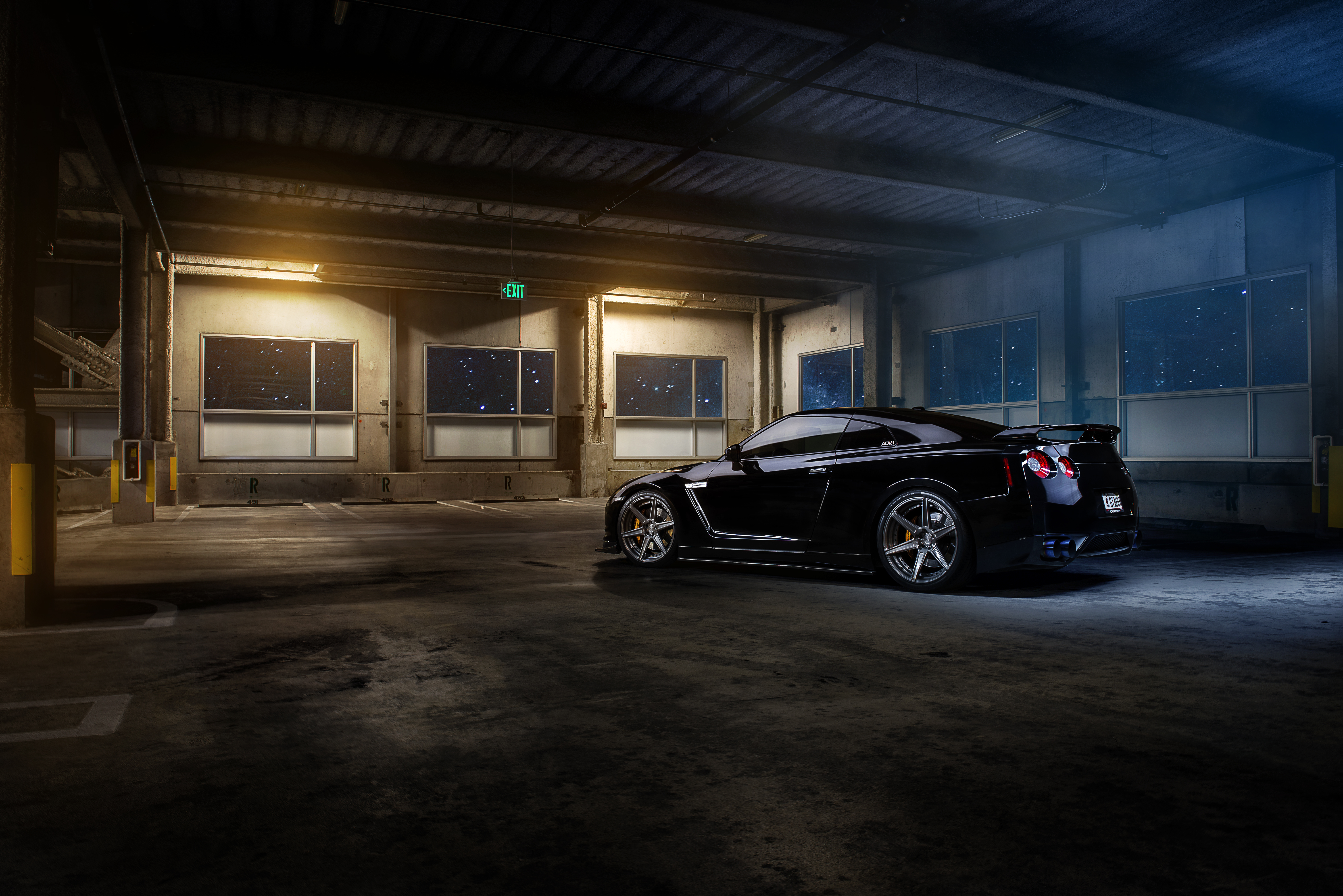Black Nissan GTR in a parking garage at night HD Wallpaper