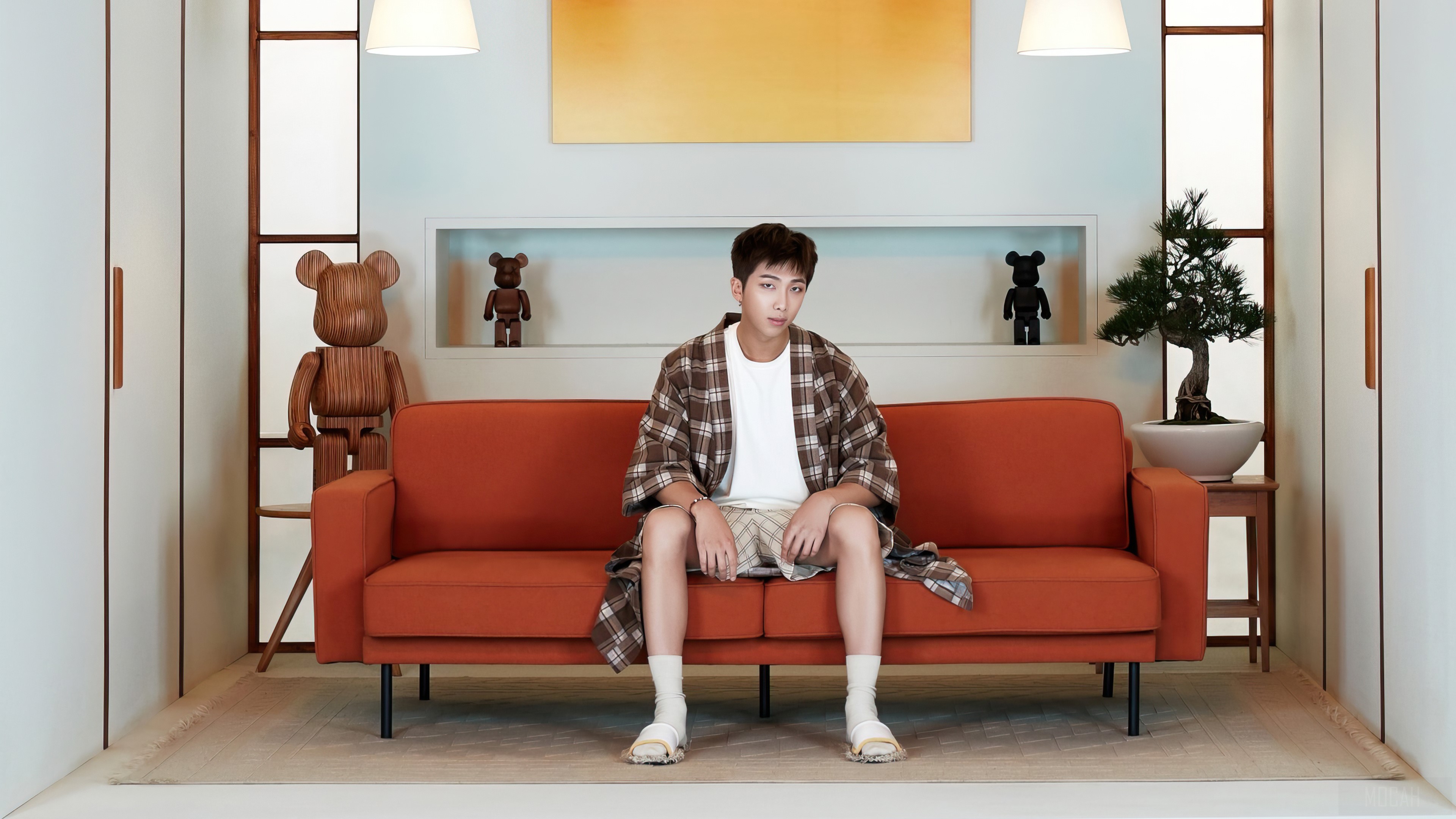 RM from BTS sitting on an orange couch HD Wallpaper