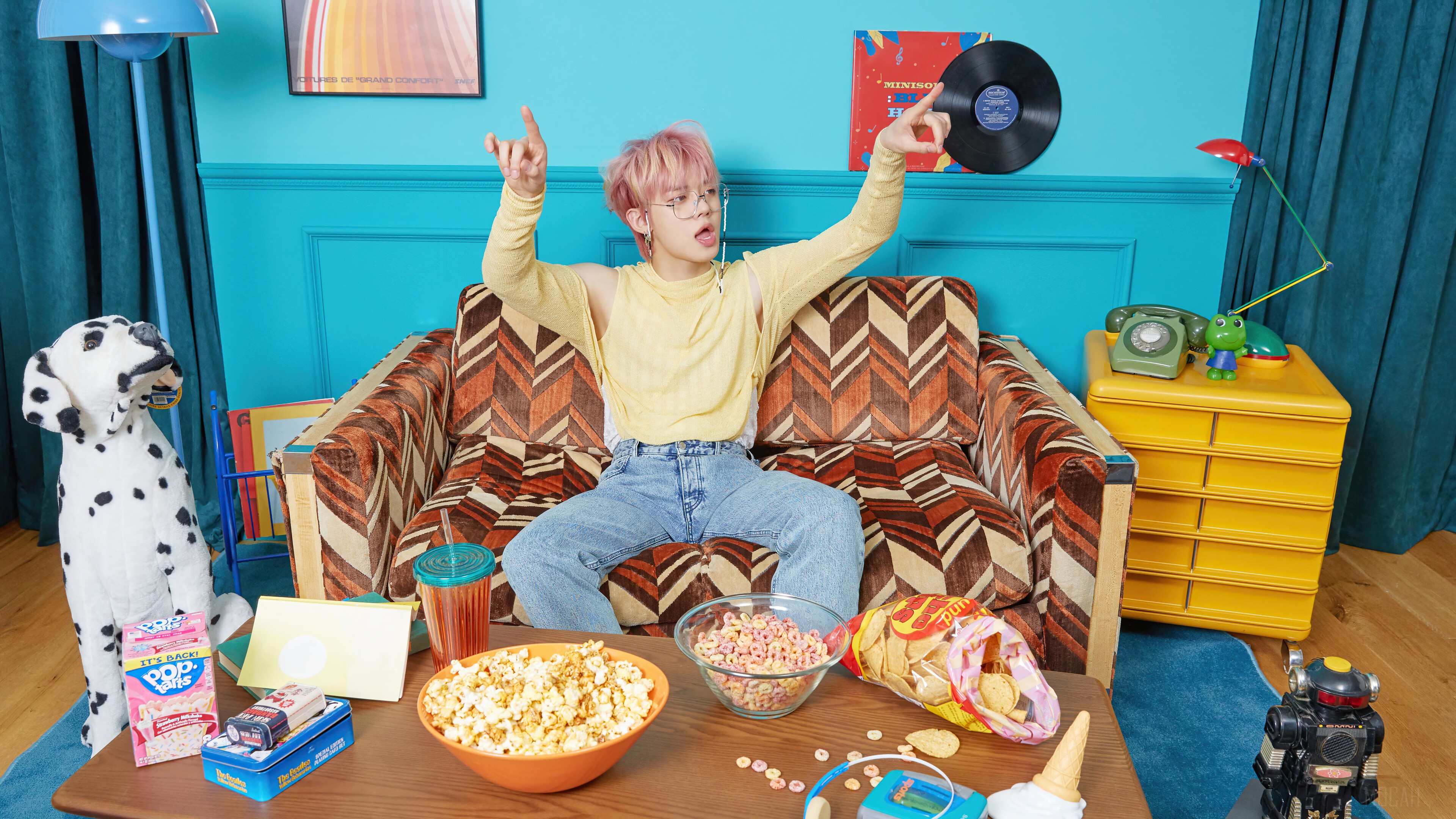 Yeonjun from TXT sitting on a couch with snacks HD Wallpaper