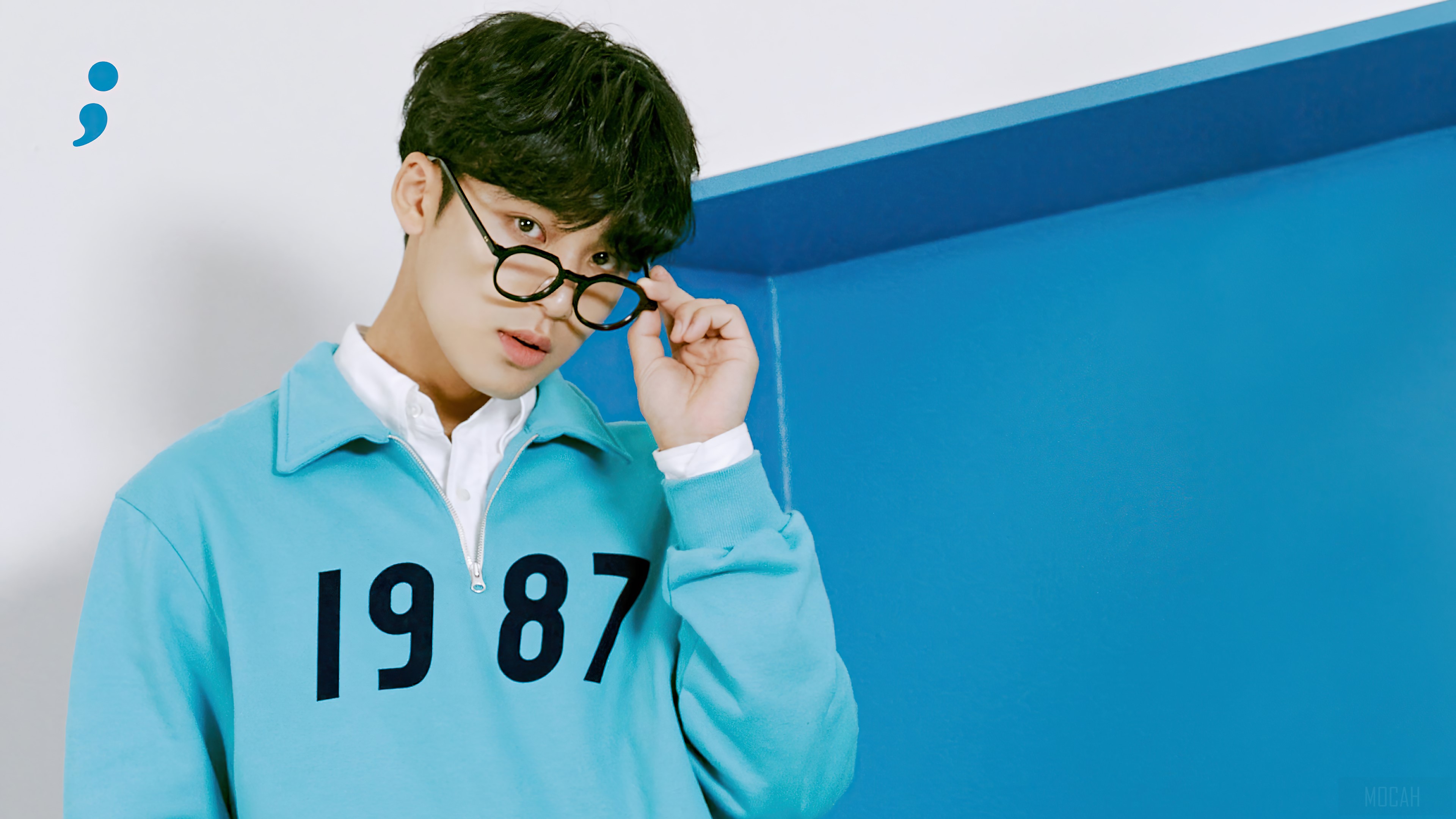 Kim Min Gyu from Seventeen wearing glasses and a blue sweatshirt HD Wallpaper