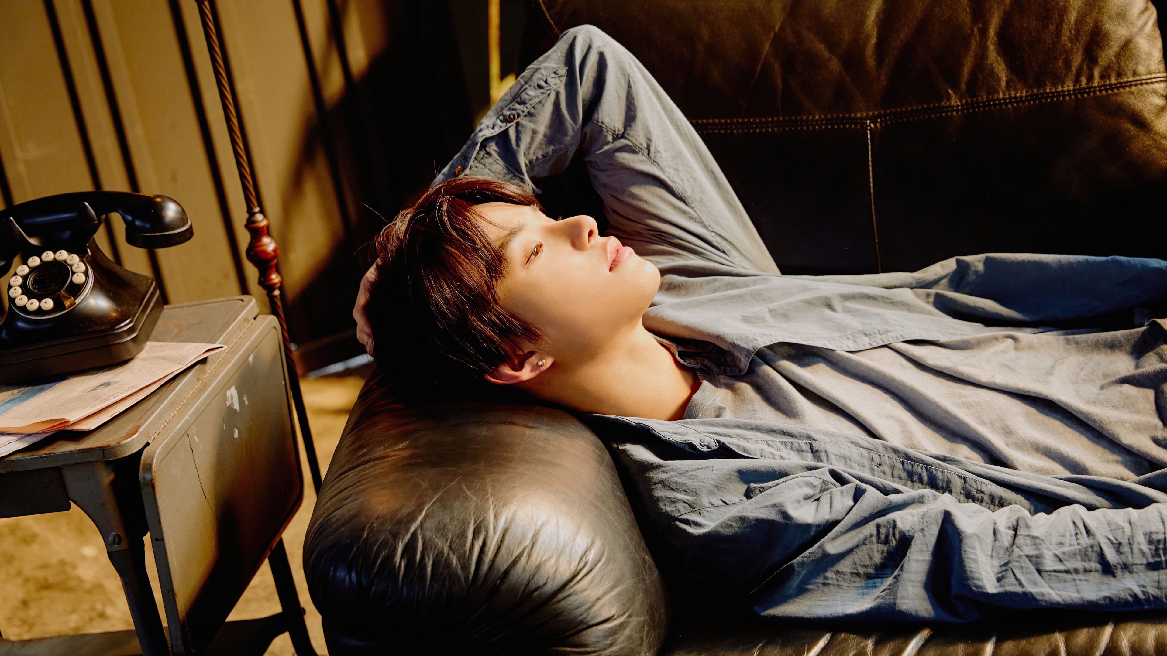 Jungwoo from NCT 127 lying on a couch HD Wallpaper