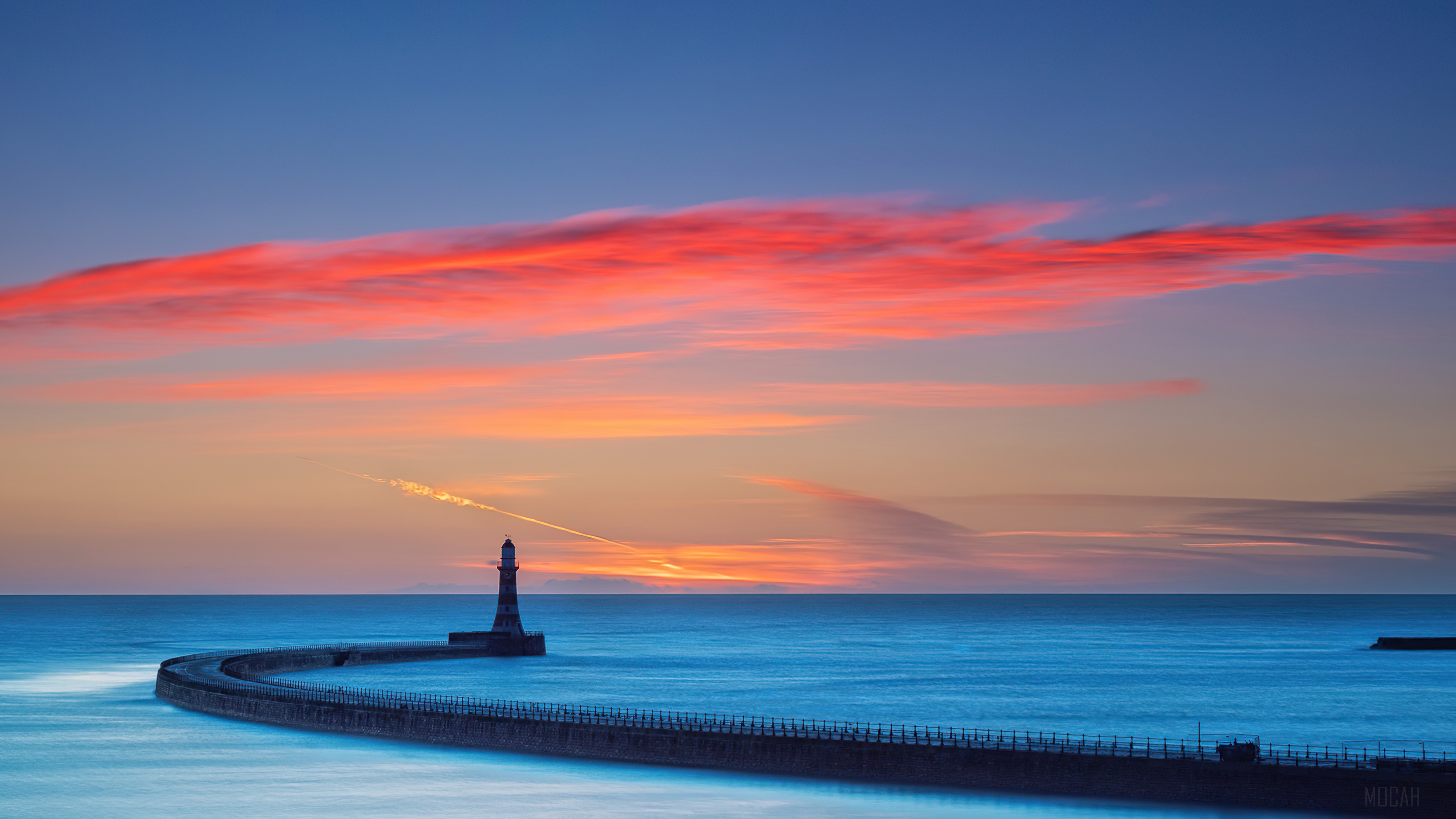 Lighthouse on a pier at sunset with colorful clouds HD Wallpaper