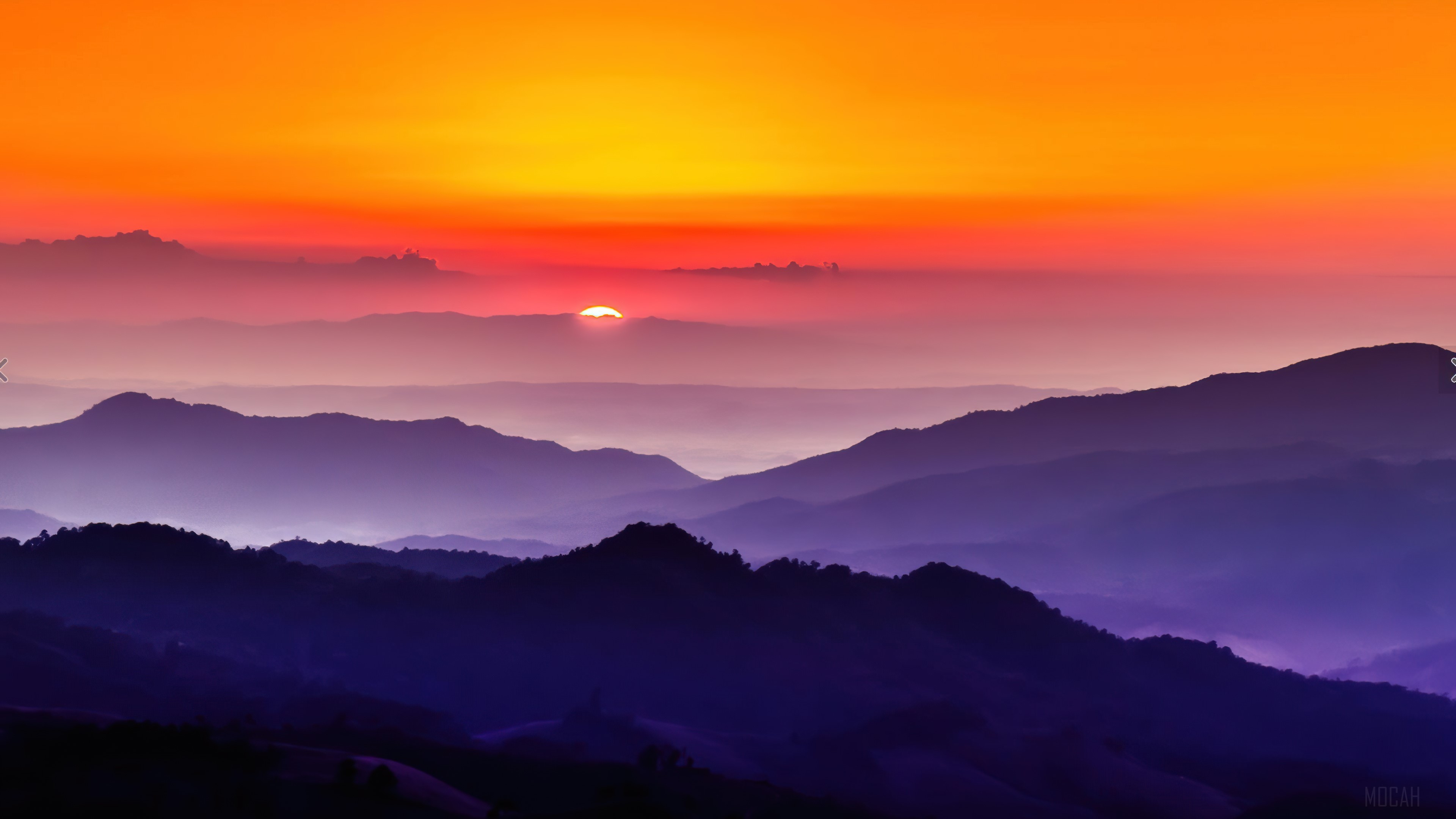 Vibrant Sunset Over Layered Mountain Landscape 4K HD Wallpaper