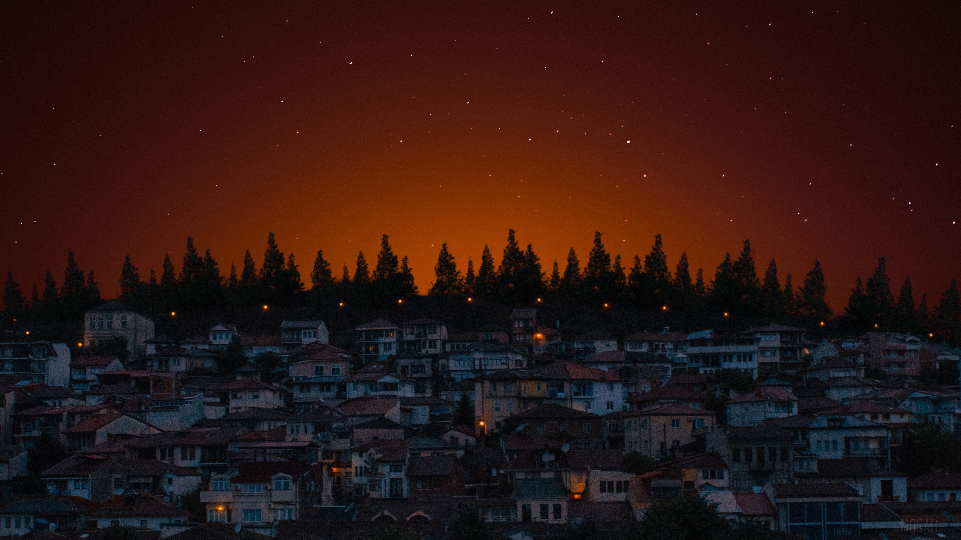 Houses on a hill at night with stars HD Wallpaper
