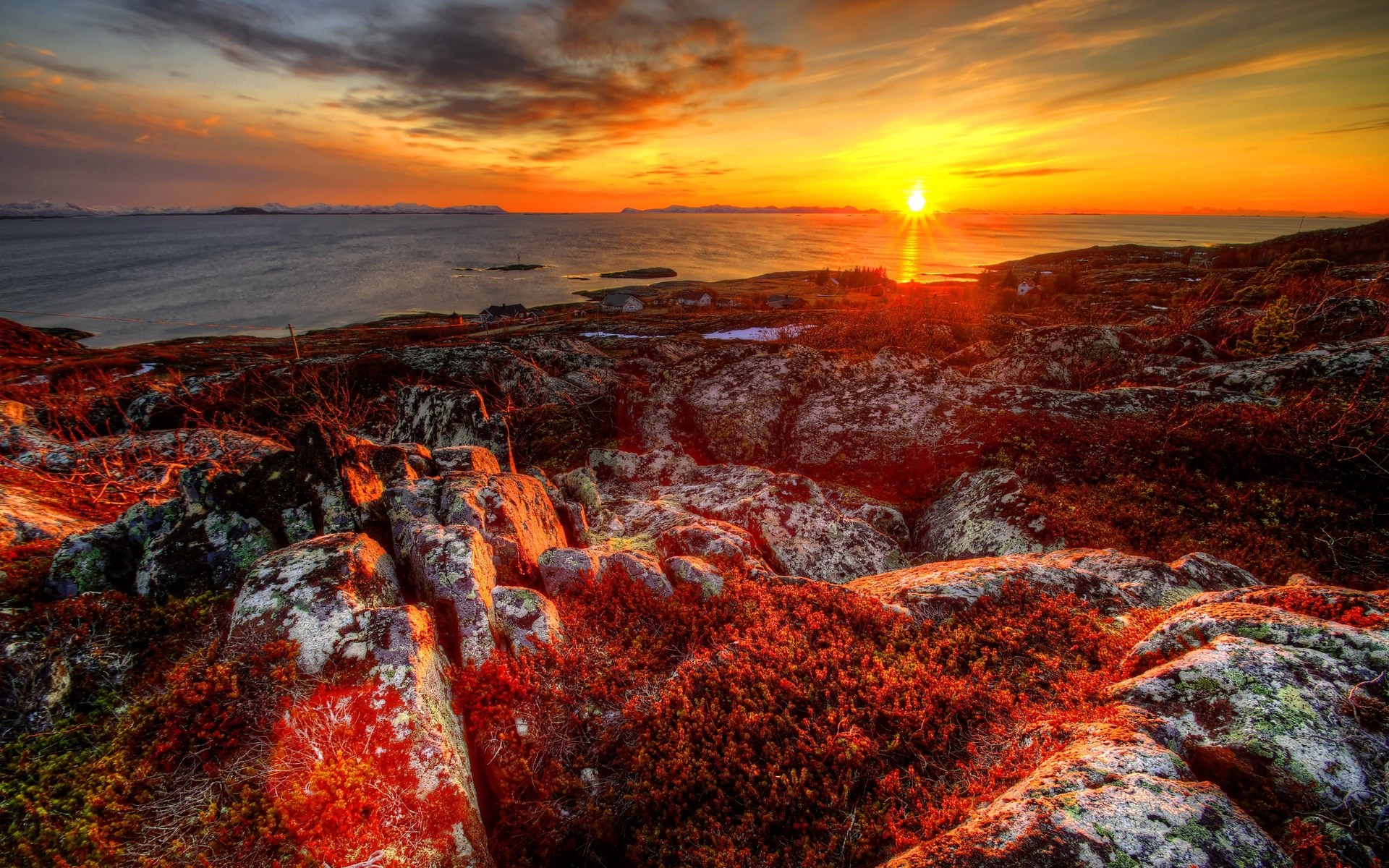 Sunset over rocky coast with ocean and mountains HD Wallpaper