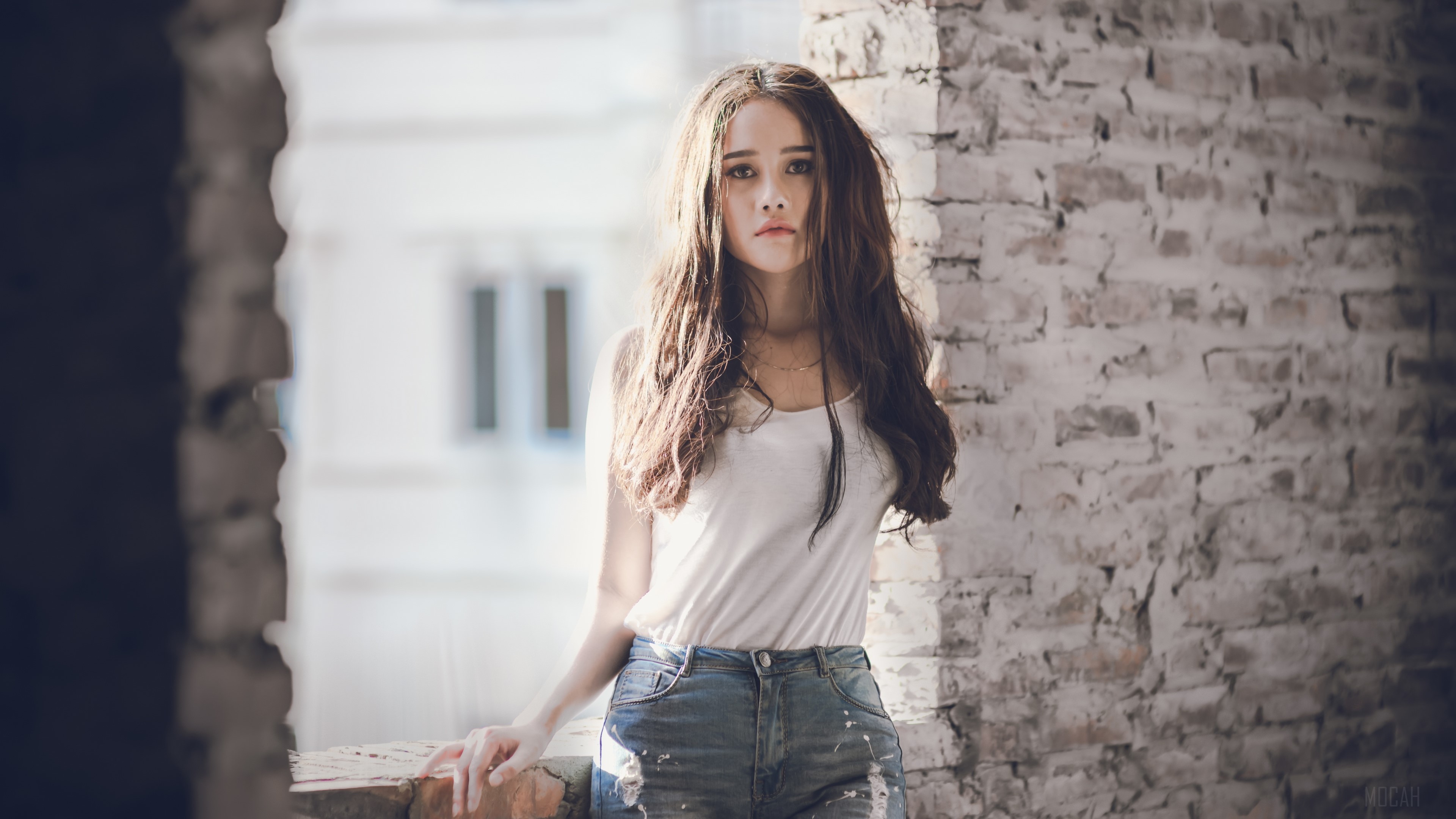 Brunette woman in white tank top and denim shorts HD Wallpaper