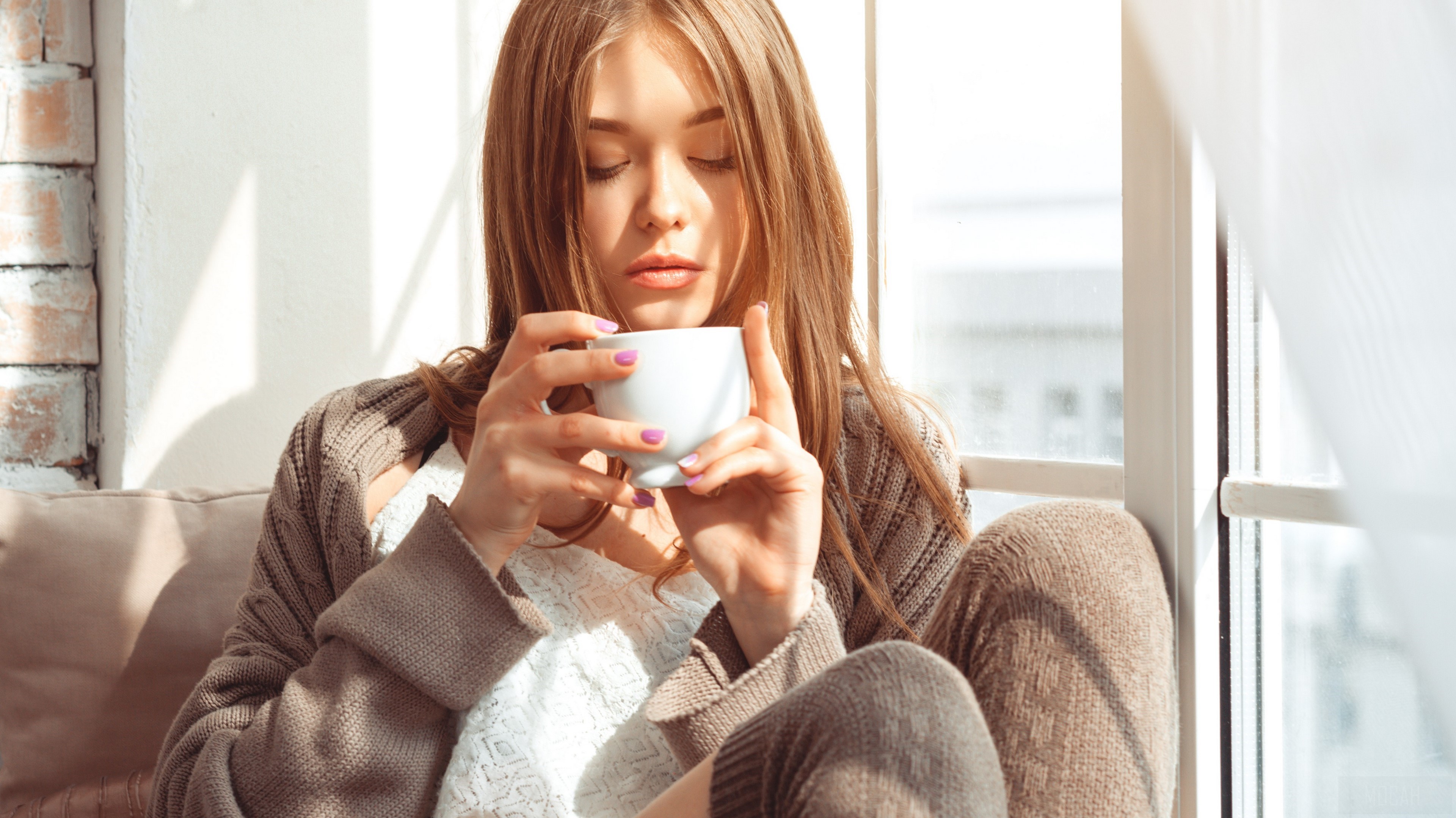 Young woman drinking from a mug by the window HD Wallpaper