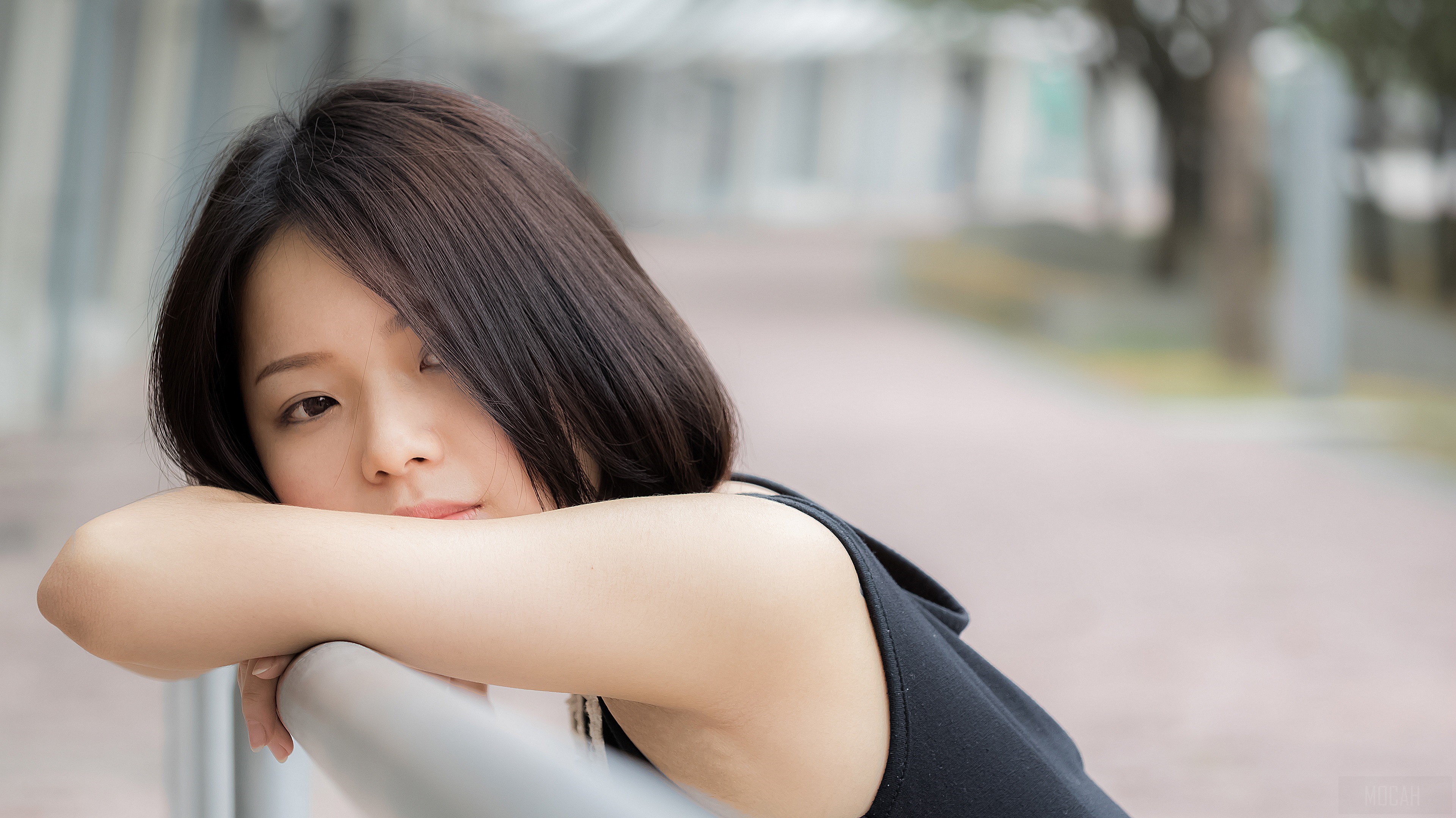 Young woman resting her head on her arms HD Wallpaper