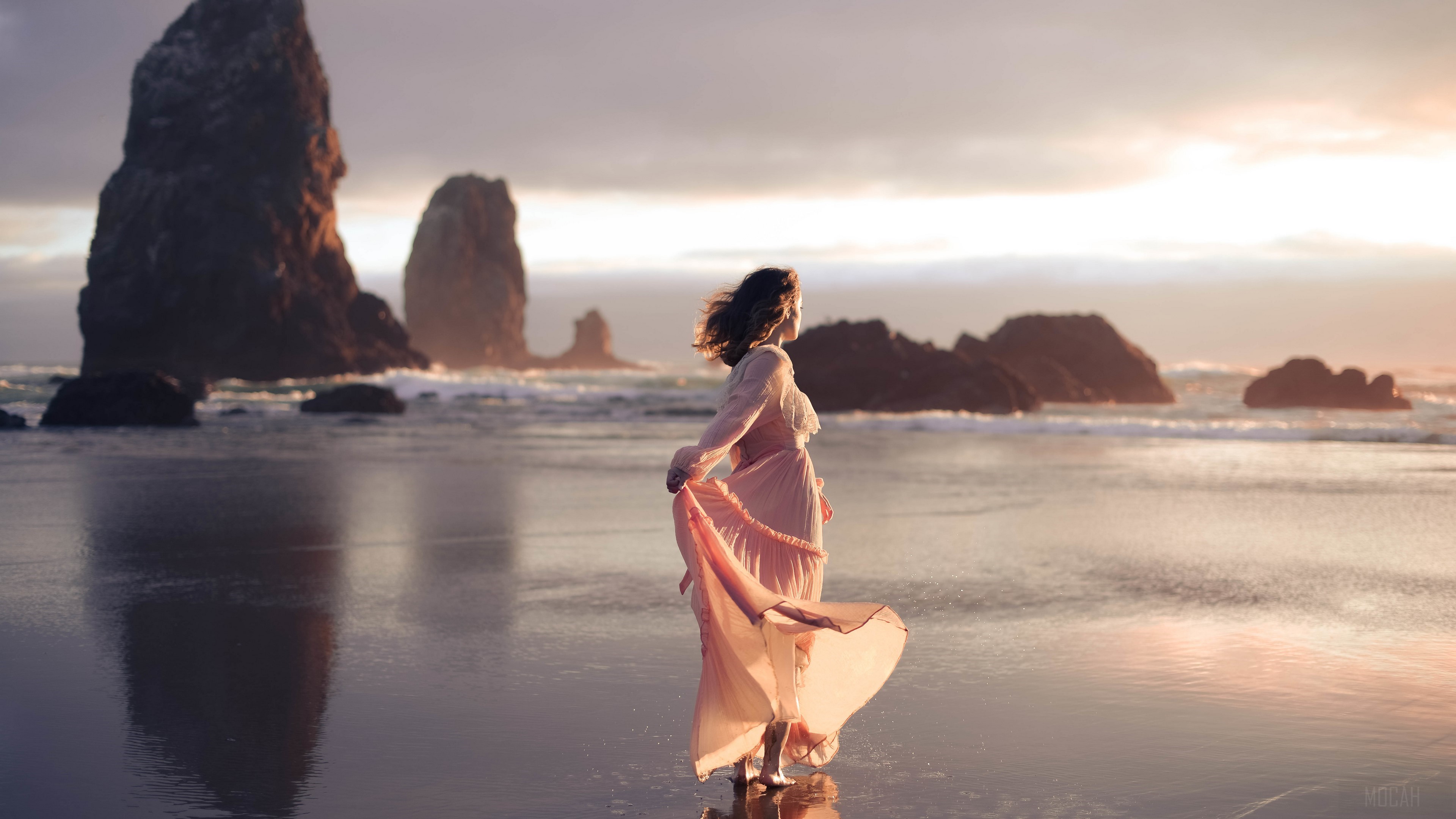 Woman in pink dress on beach with sea stacks HD Wallpaper