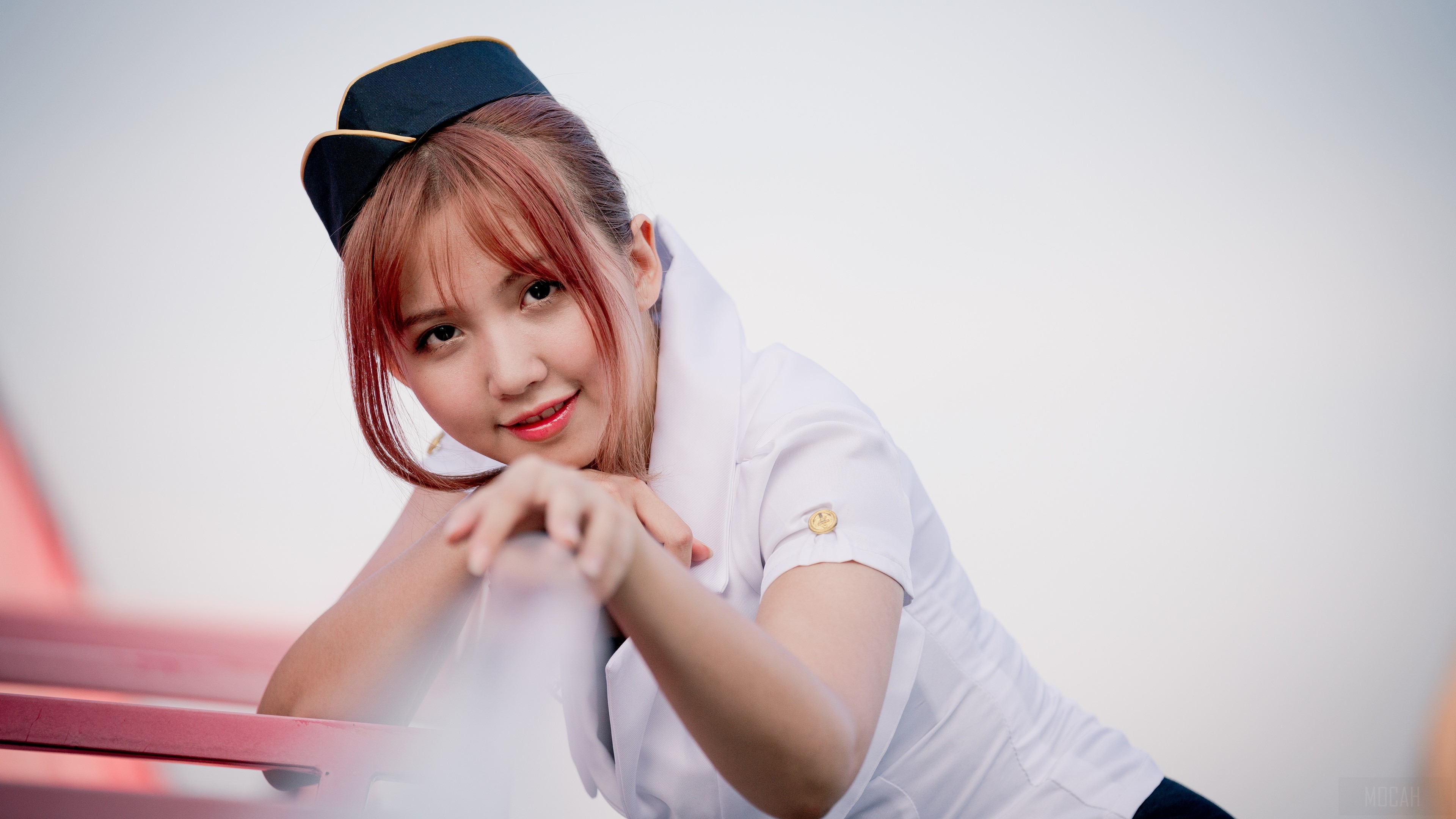 Young woman in flight attendant uniform HD Wallpaper