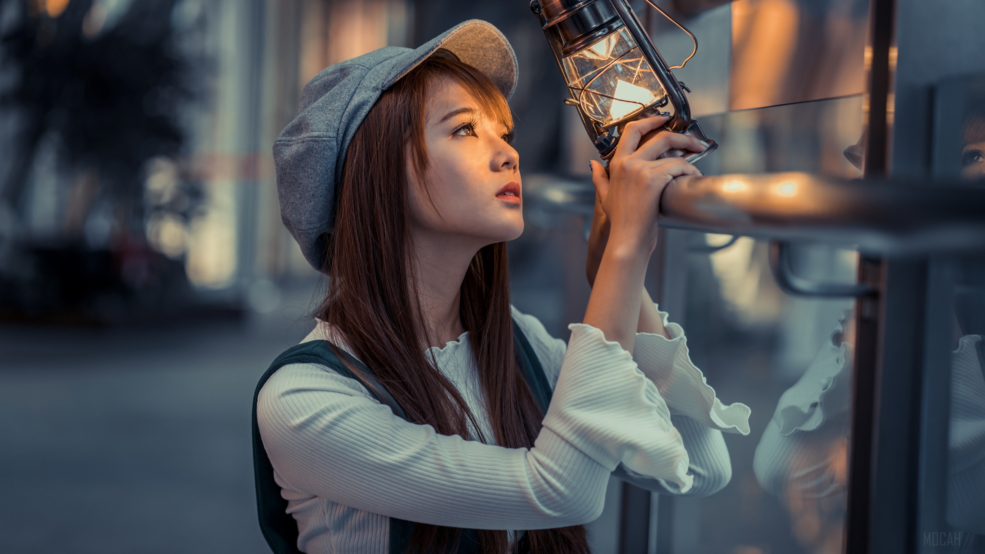 Woman Holding Lantern in Warm Light 4K HD Wallpaper
