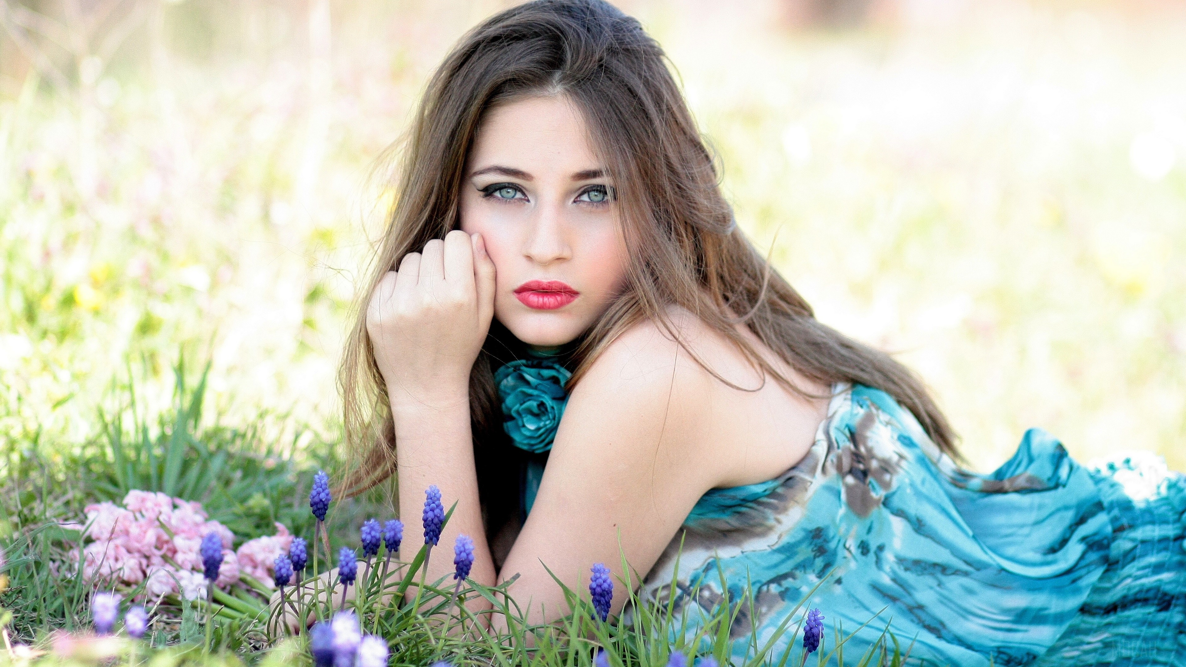 Brunette girl with flowers in grass 4K HD Wallpaper