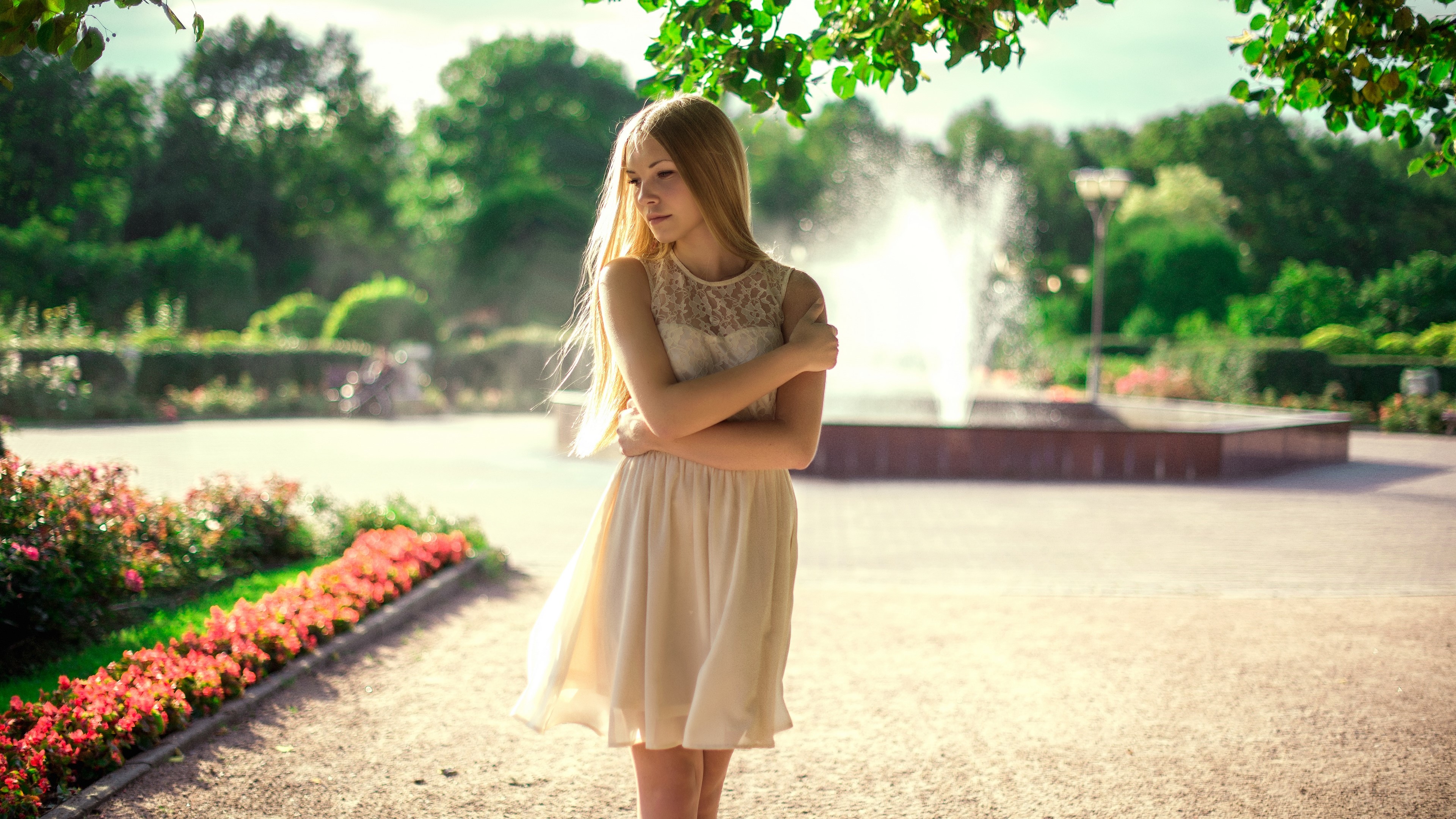 Young woman in a park with a fountain HD Wallpaper