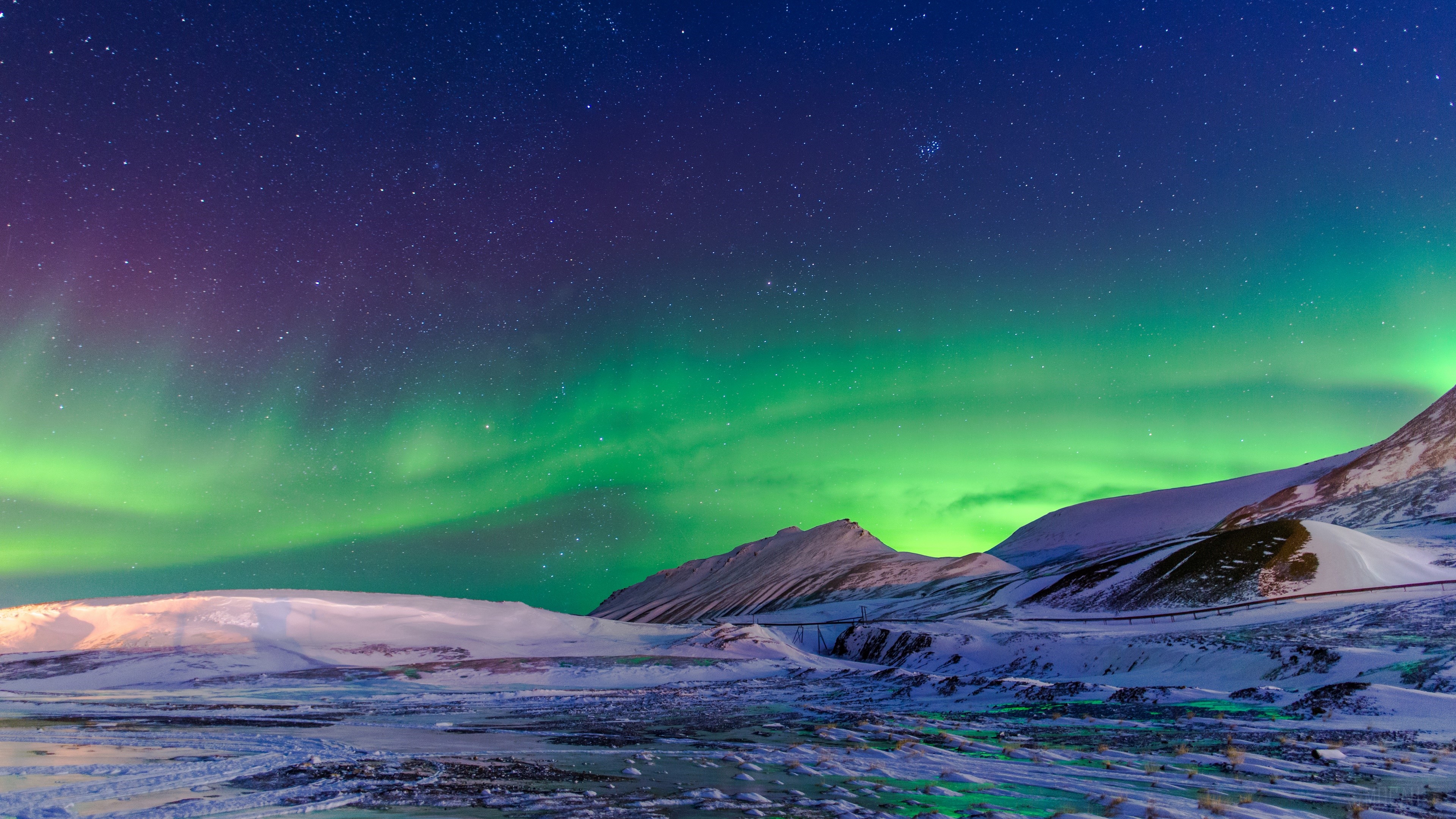 Aurora Borealis over snowy mountains and starry sky 4K HD Wallpaper