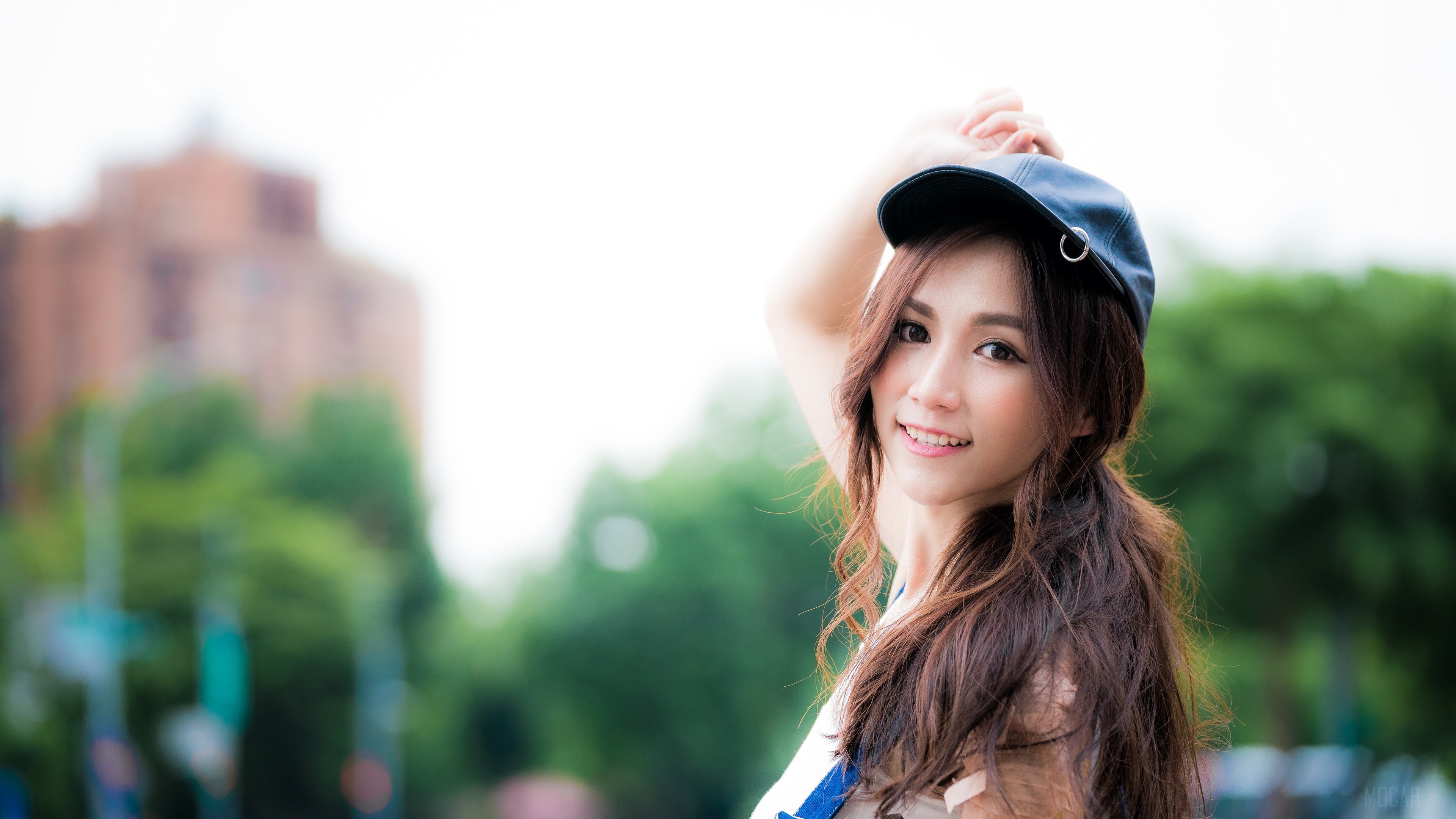Woman wearing a cap and smiling HD Wallpaper