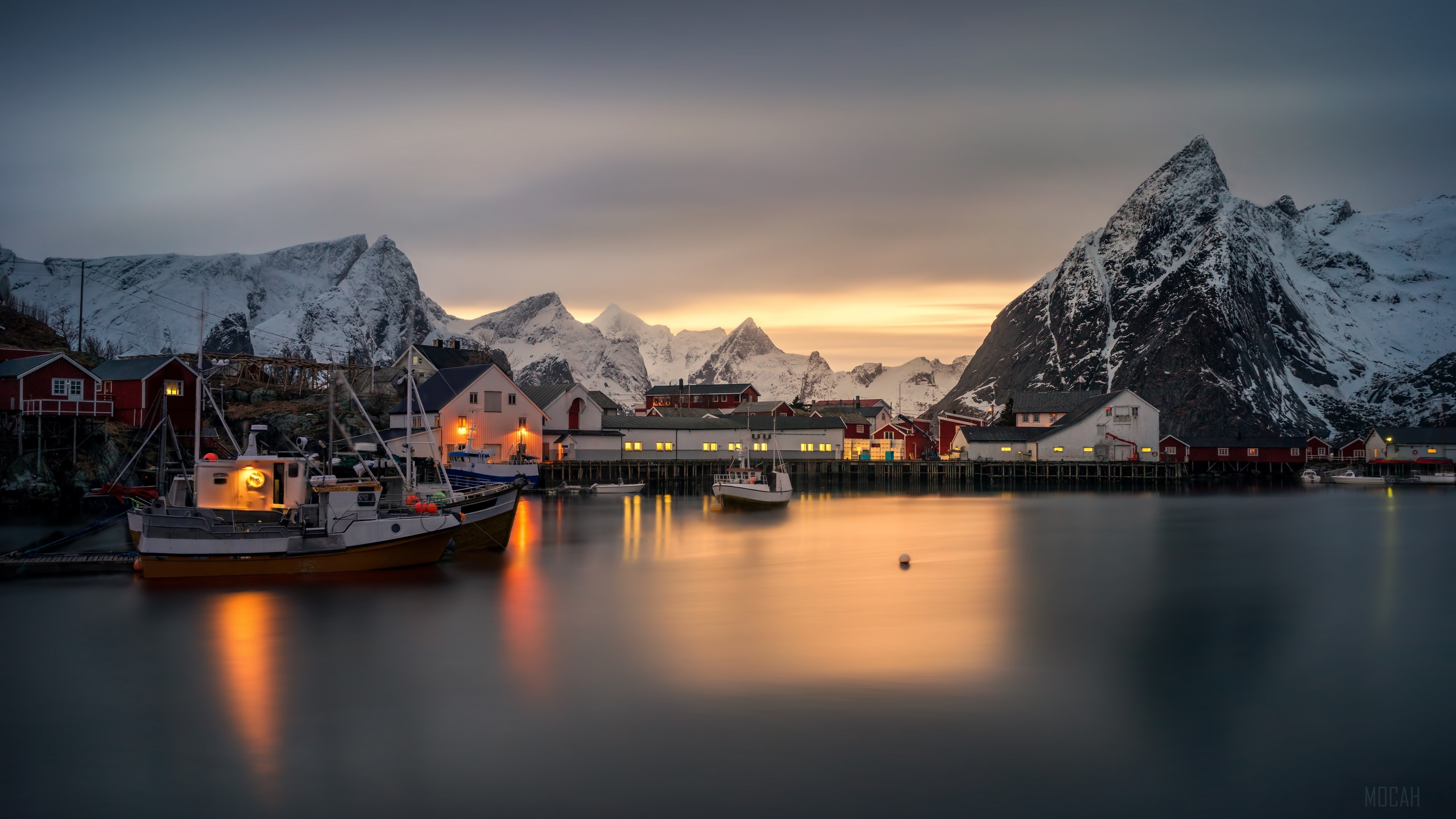 Fishing village with snow-capped mountains at dusk HD Wallpaper