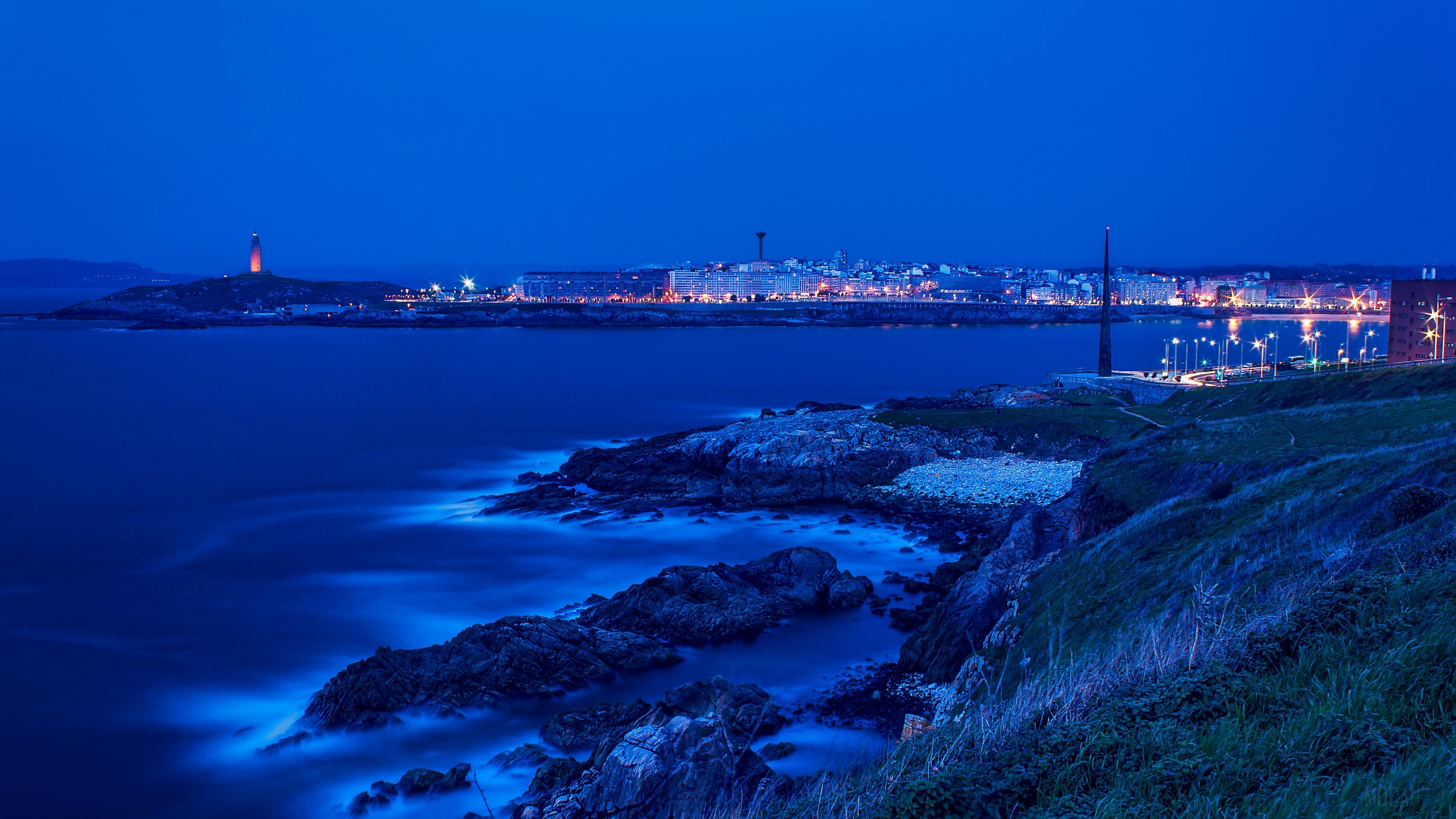 Cityscape and Lighthouse at Dusk HD Wallpaper