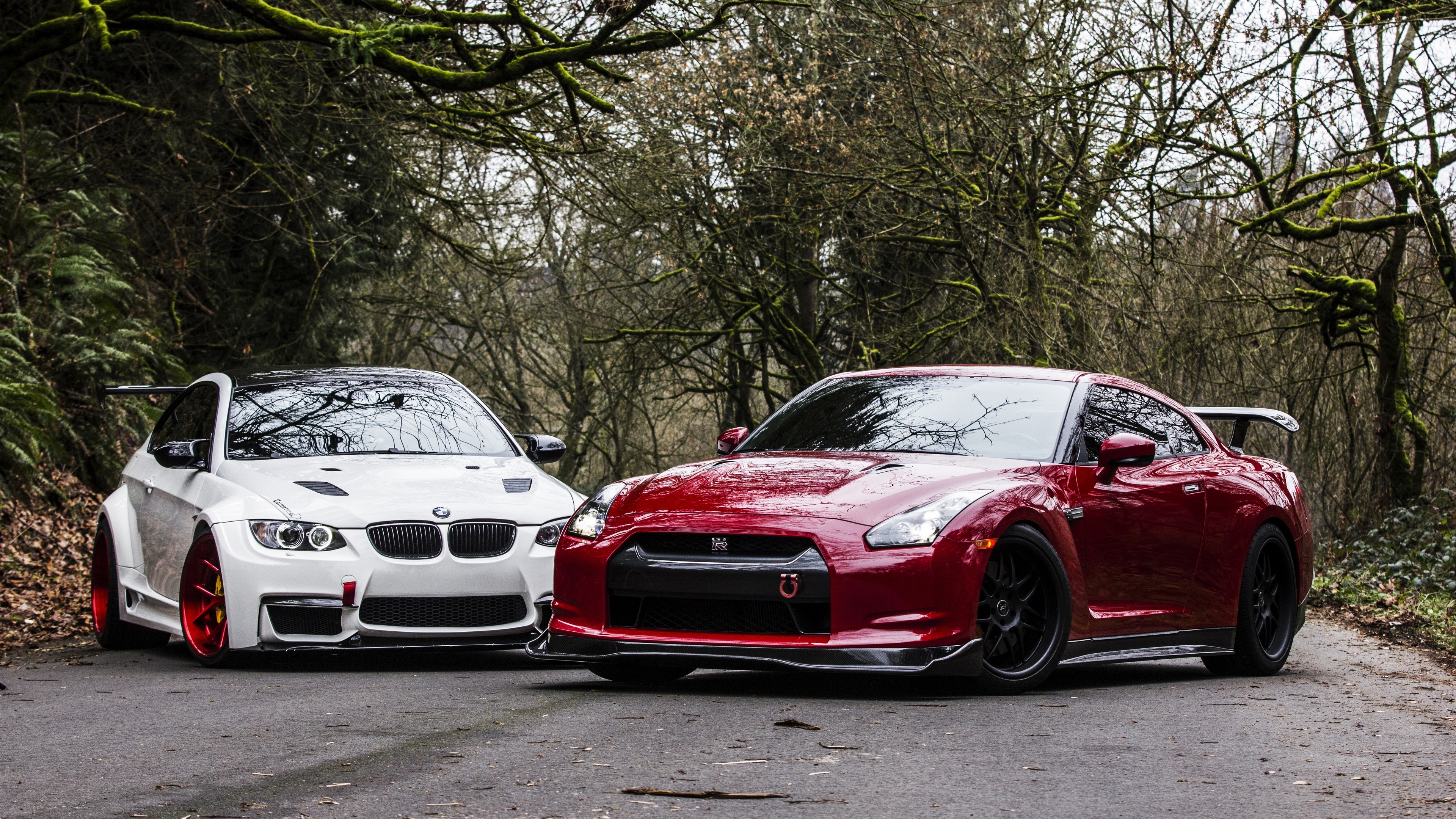 White BMW M3 and red Nissan GT-R parked on a road HD Wallpaper
