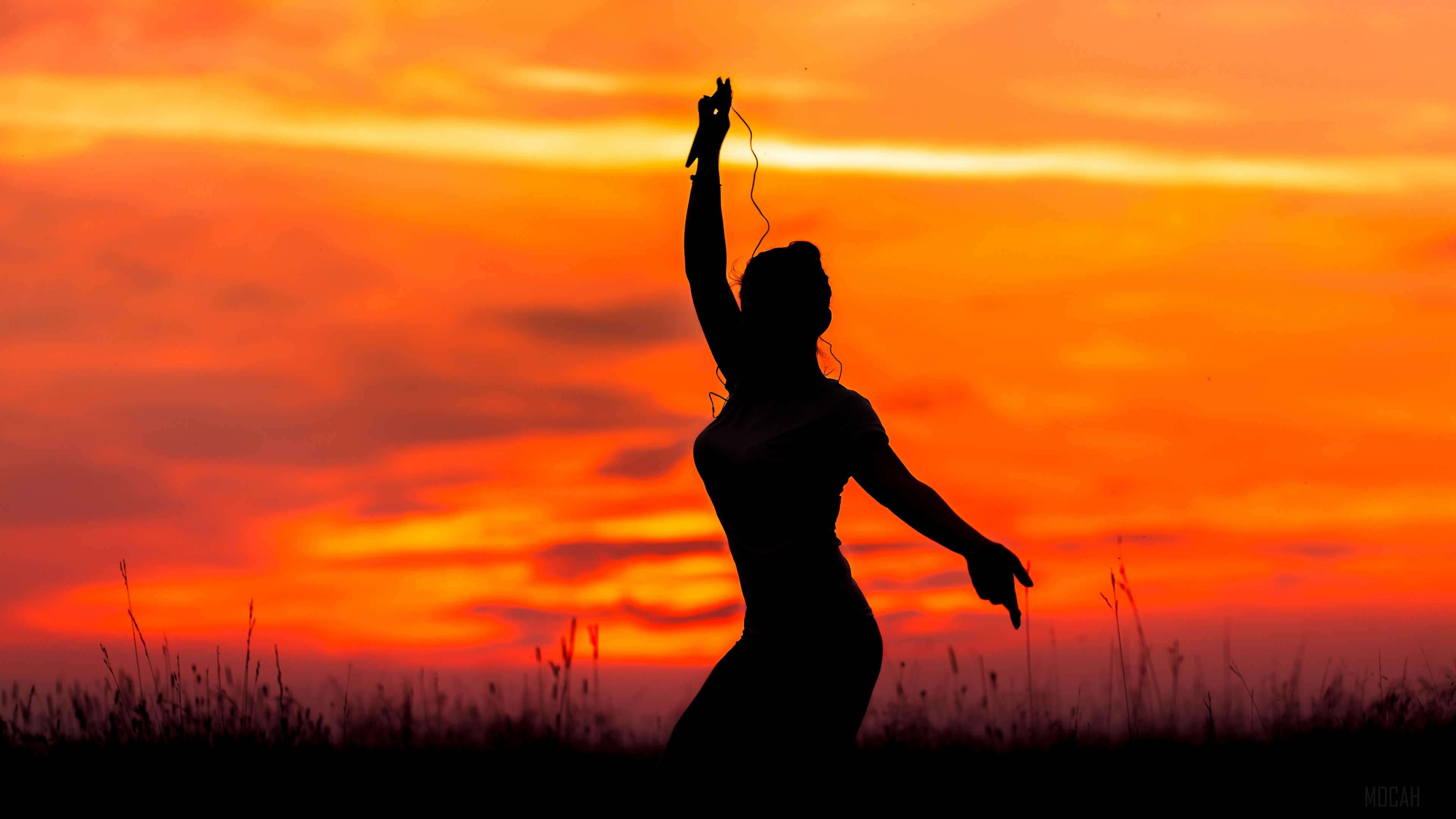 Silhouette of a woman dancing at sunset HD Wallpaper