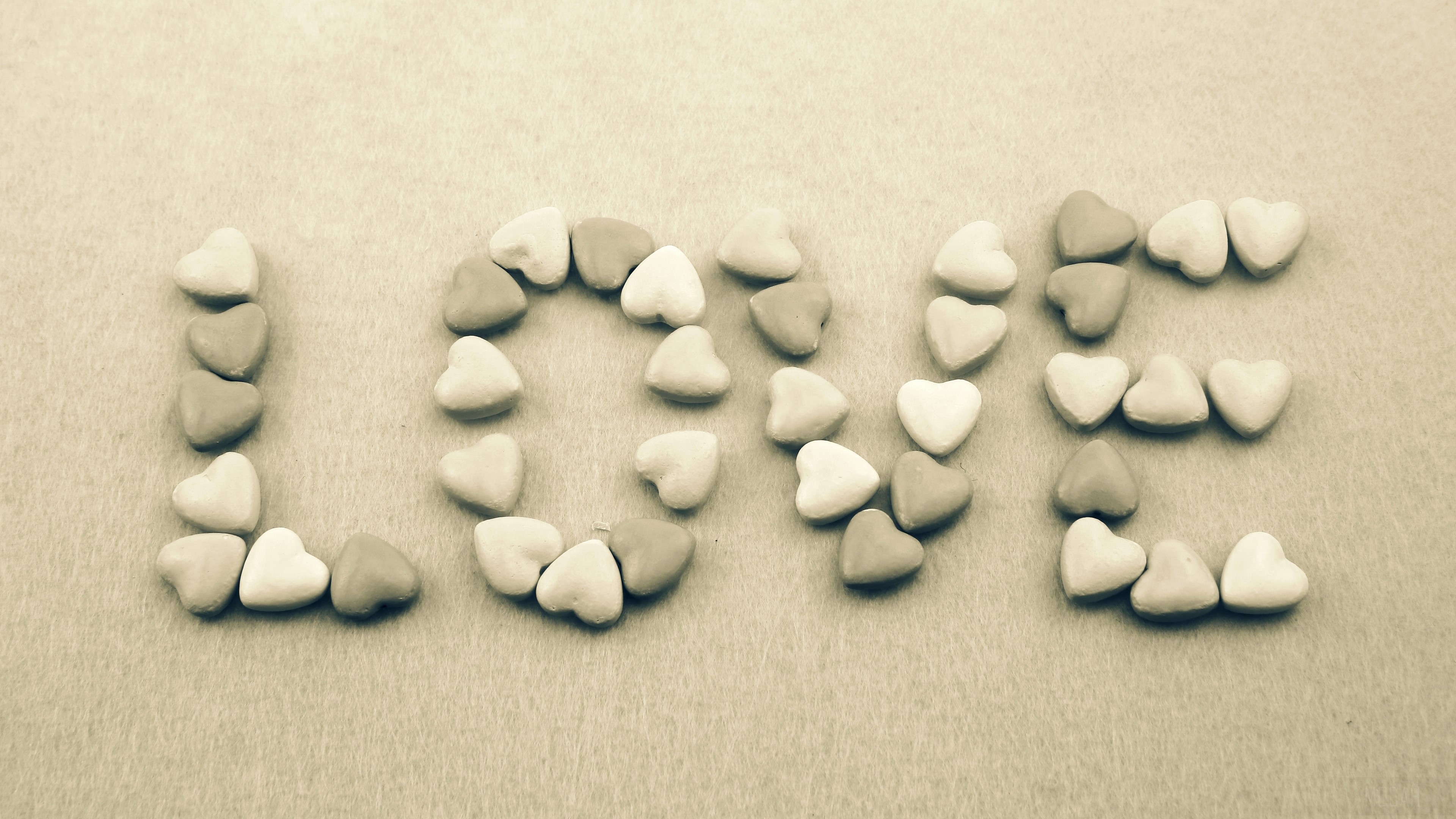 Love spelled with heart-shaped candies HD Wallpaper