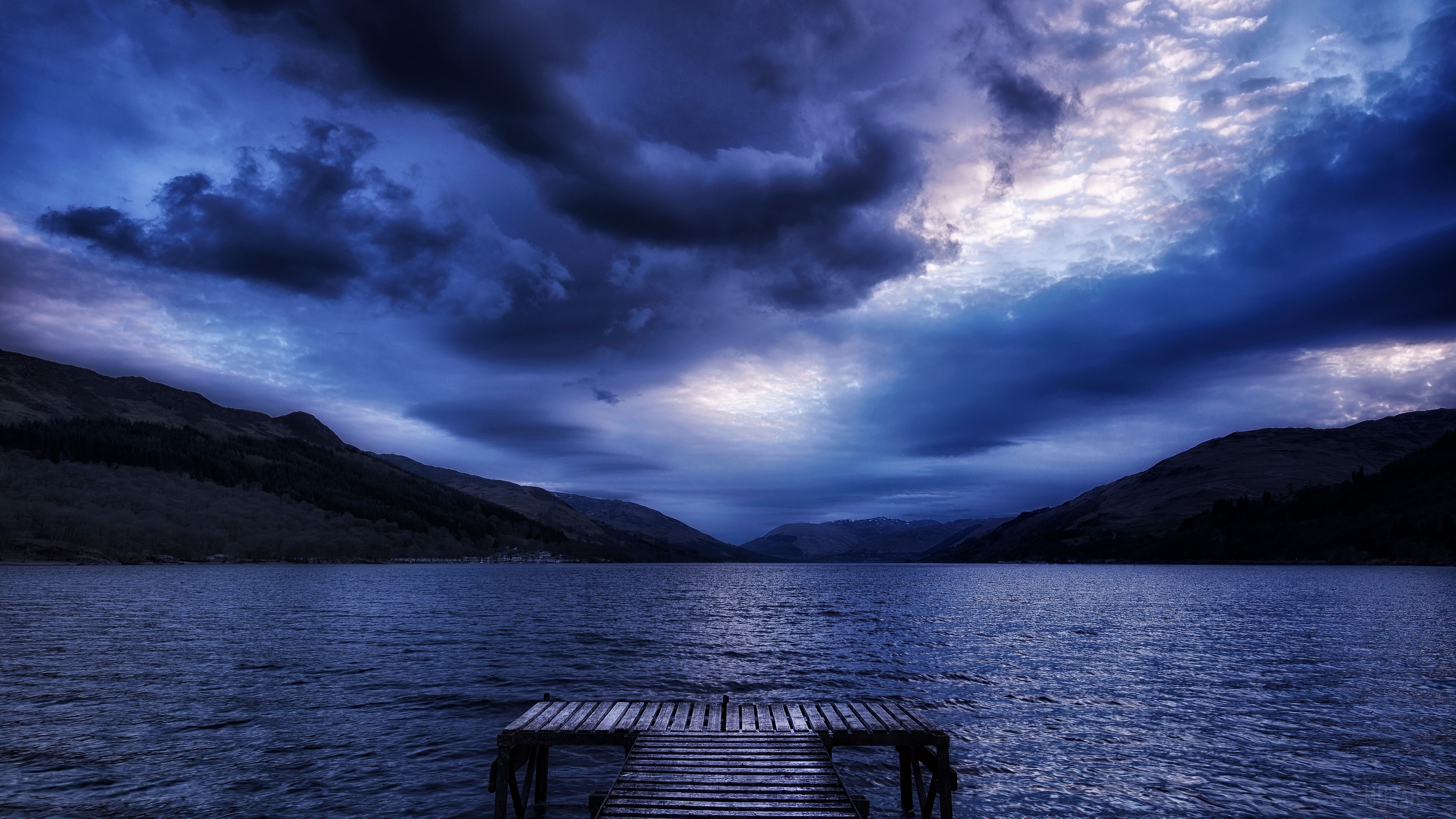 Dark Blue Clouds Over Lake with Pier 4K HD Wallpaper