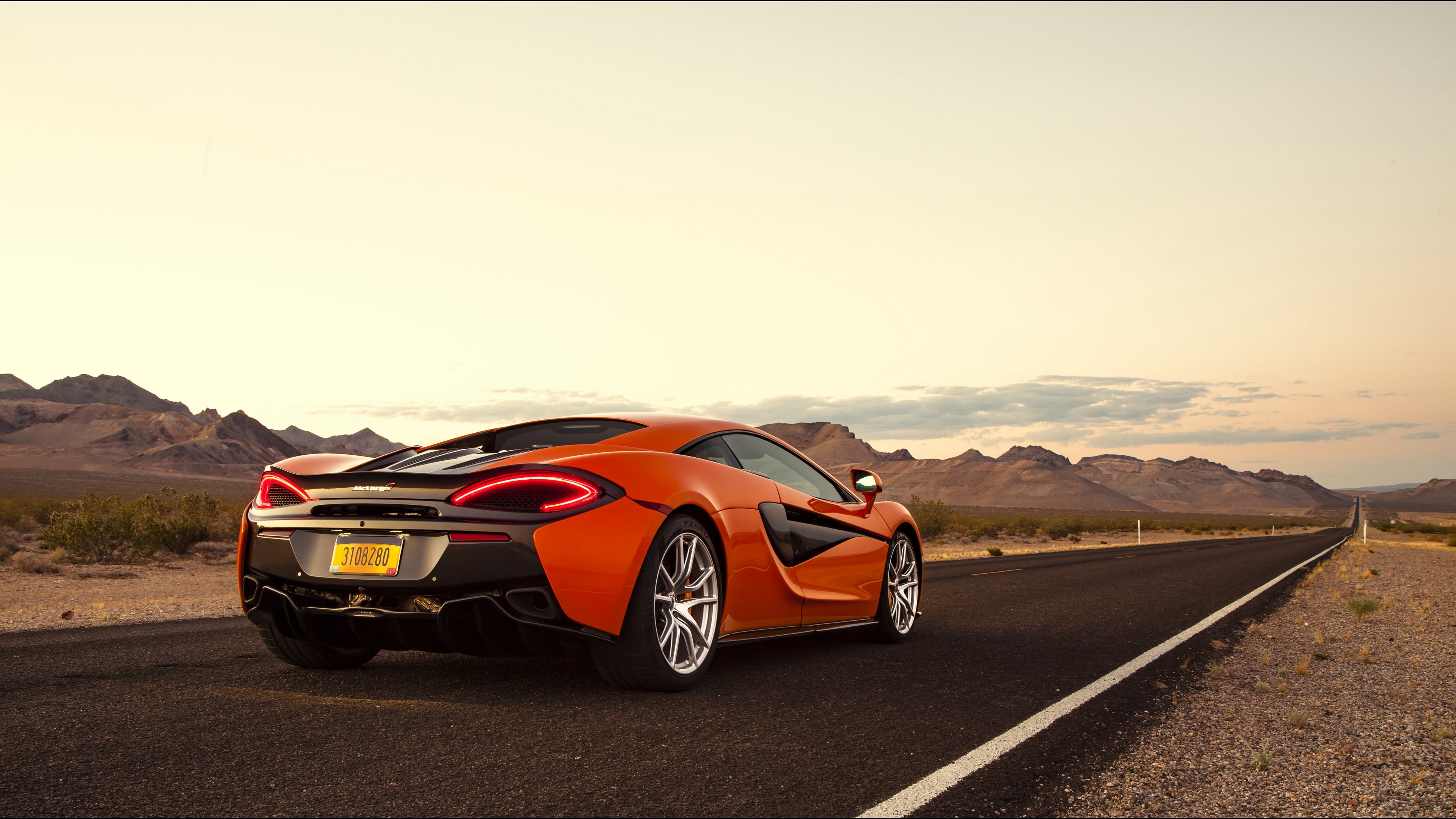 Orange McLaren 570S Supercar on Desert Road 4K HD Wallpaper