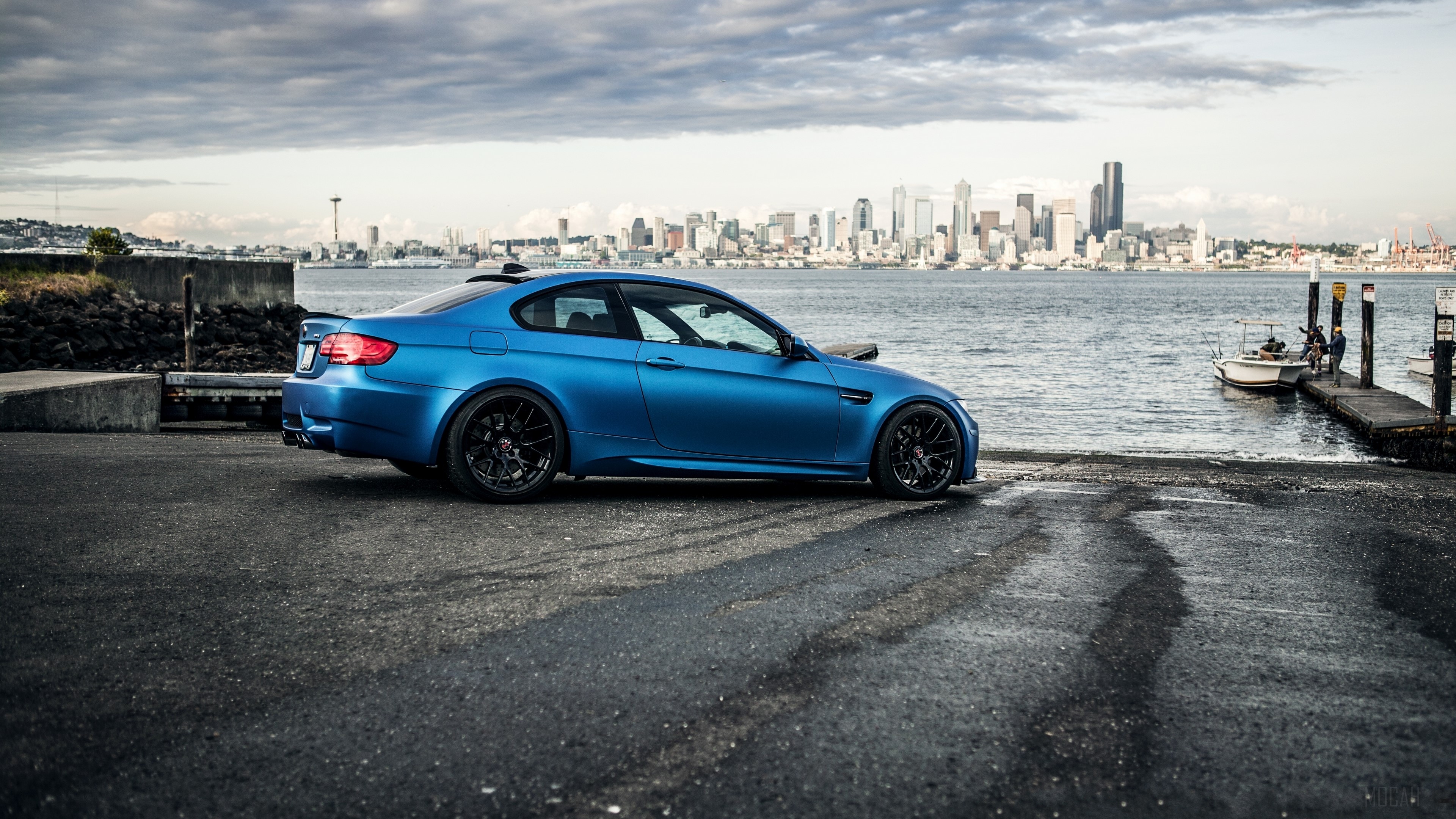 Blue BMW M3 Coupe by the Water with City Skyline HD Wallpaper