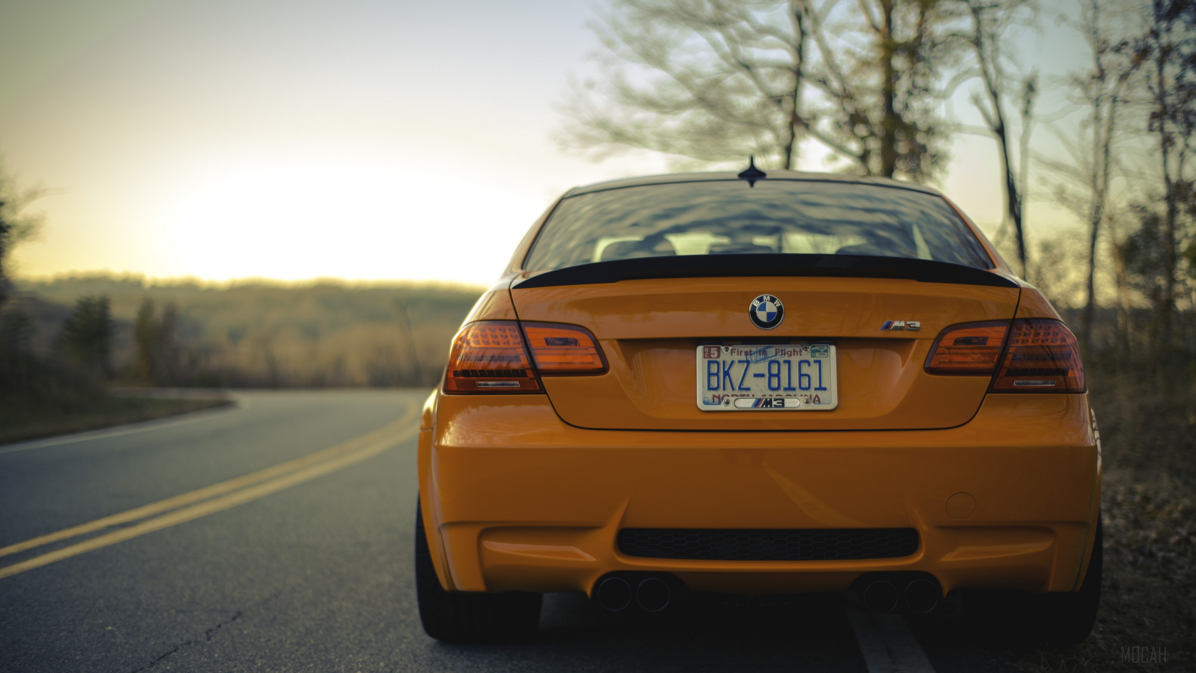 Orange BMW M3 on a Winding Road HD Wallpaper