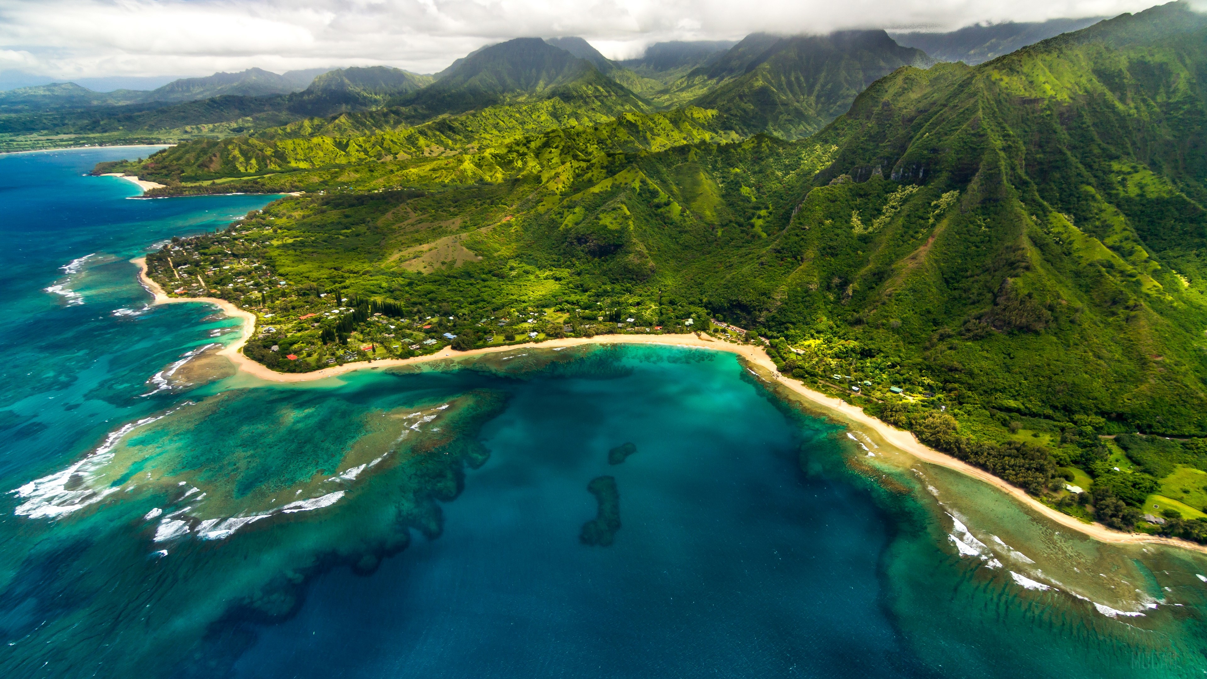 Aerial view of Maniniholo Bay, Hawaii, with mountains HD Wallpaper