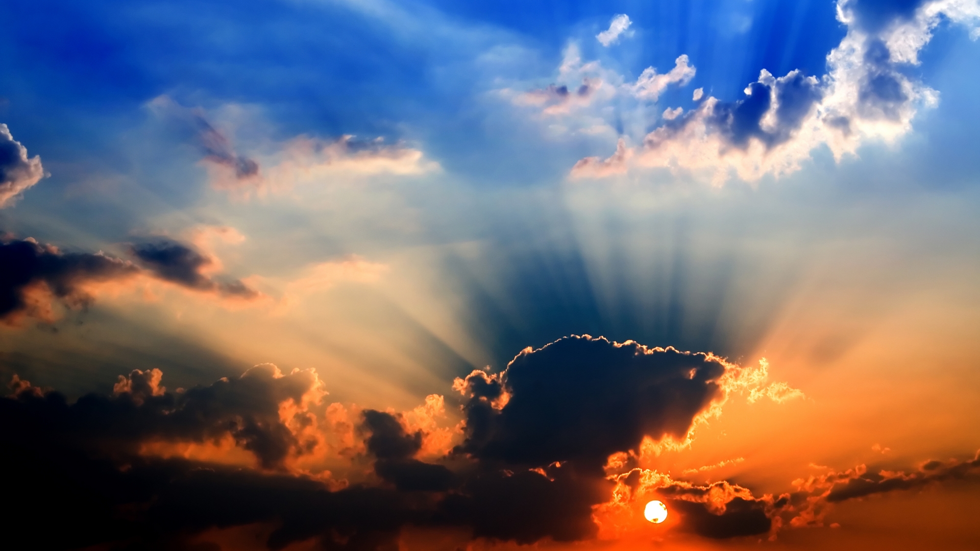 Sunbeams shining through clouds at sunset HD Wallpaper