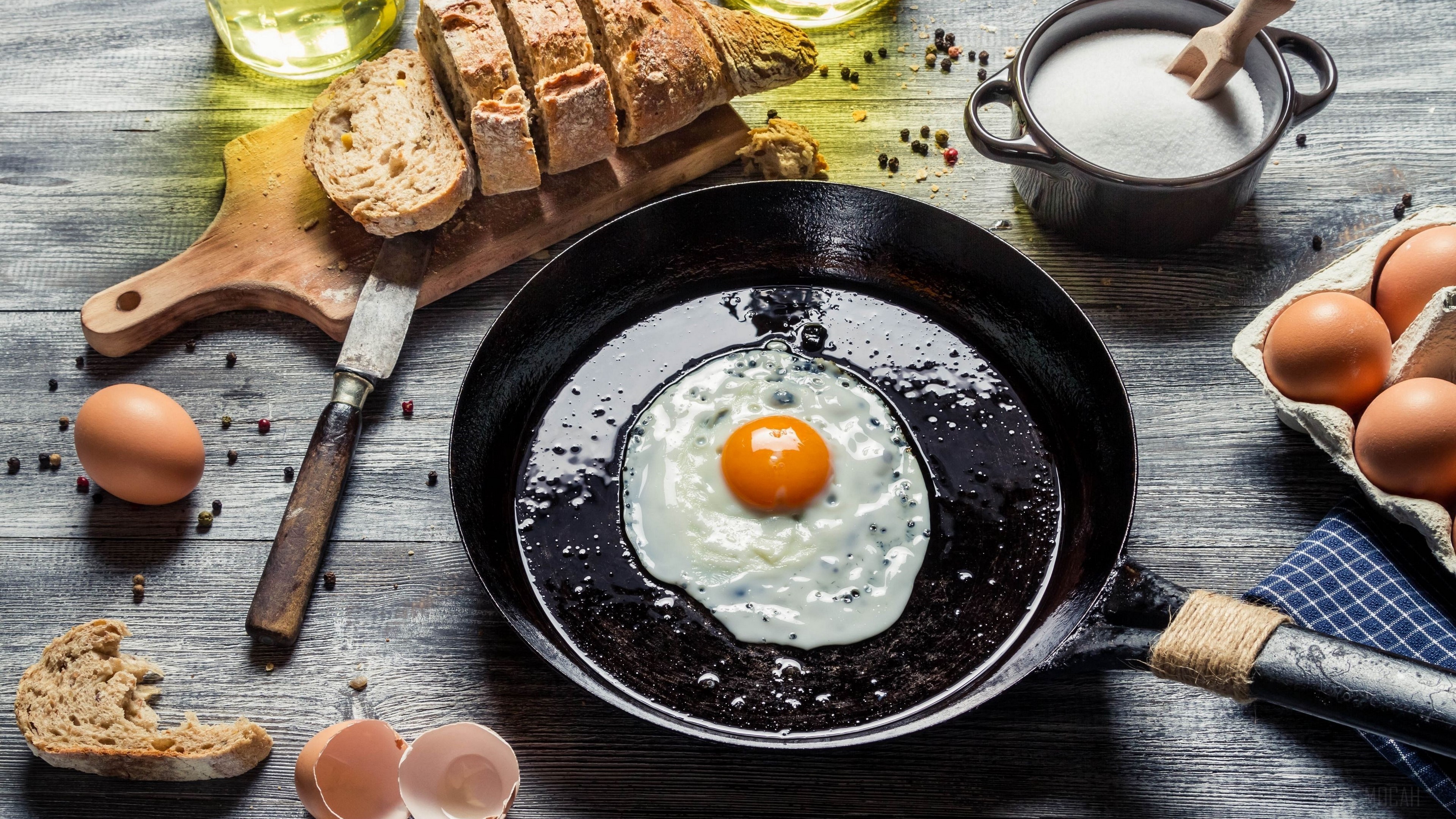 Fried egg in a pan with bread and eggs HD Wallpaper