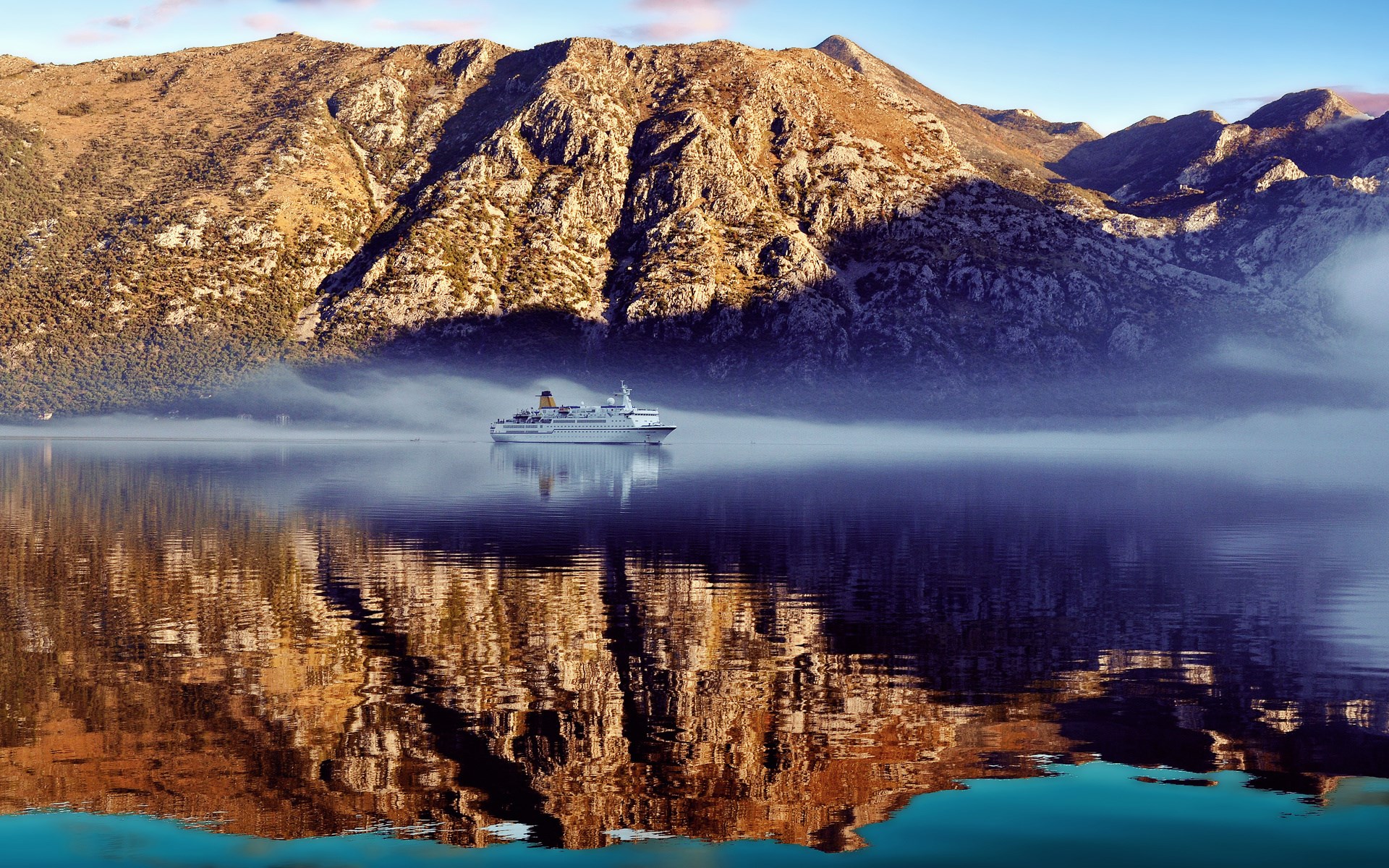 Cruise ship on a misty bay with mountains HD Wallpaper
