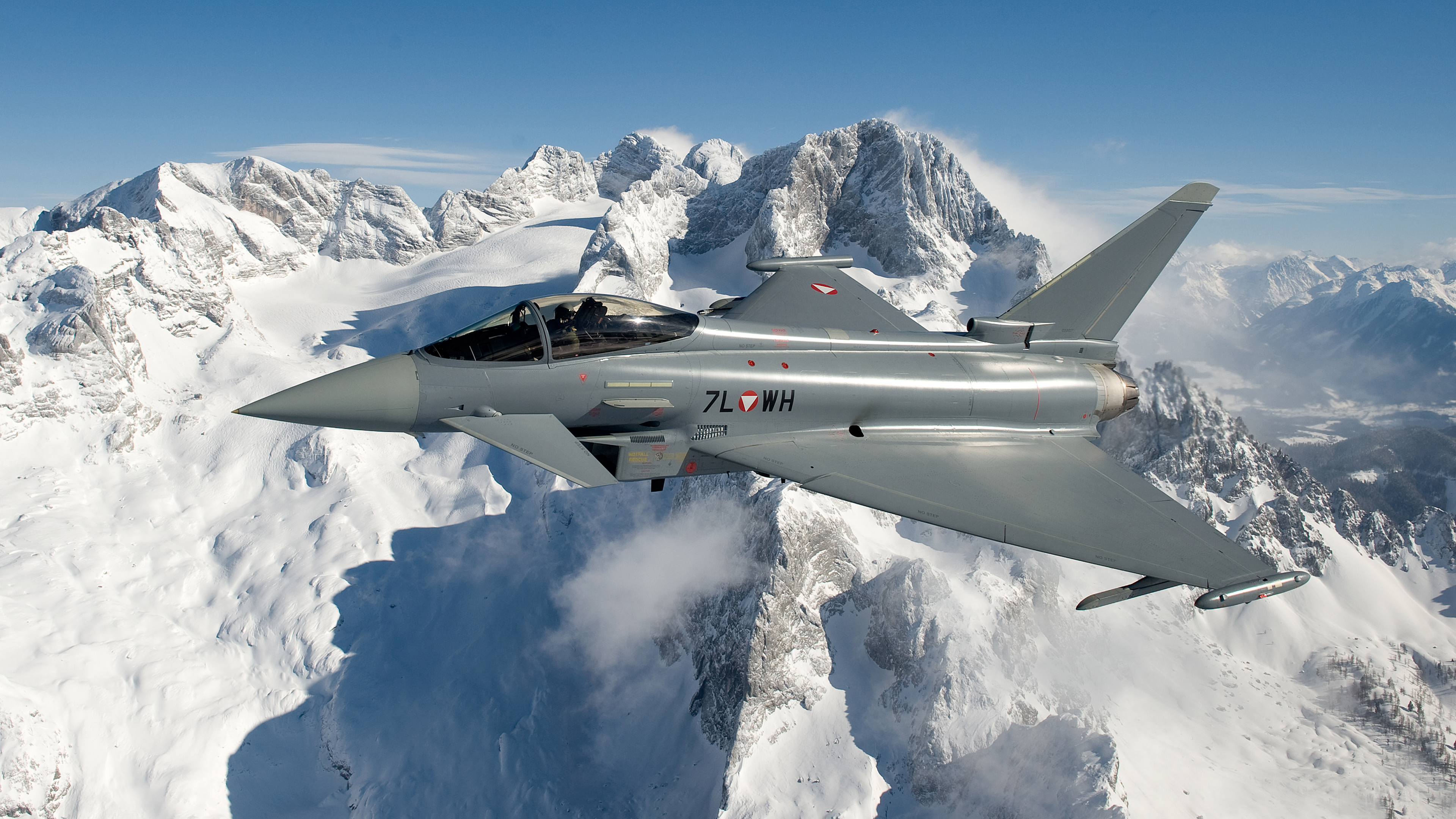 Eurofighter Typhoon flying over snowy mountains HD Wallpaper