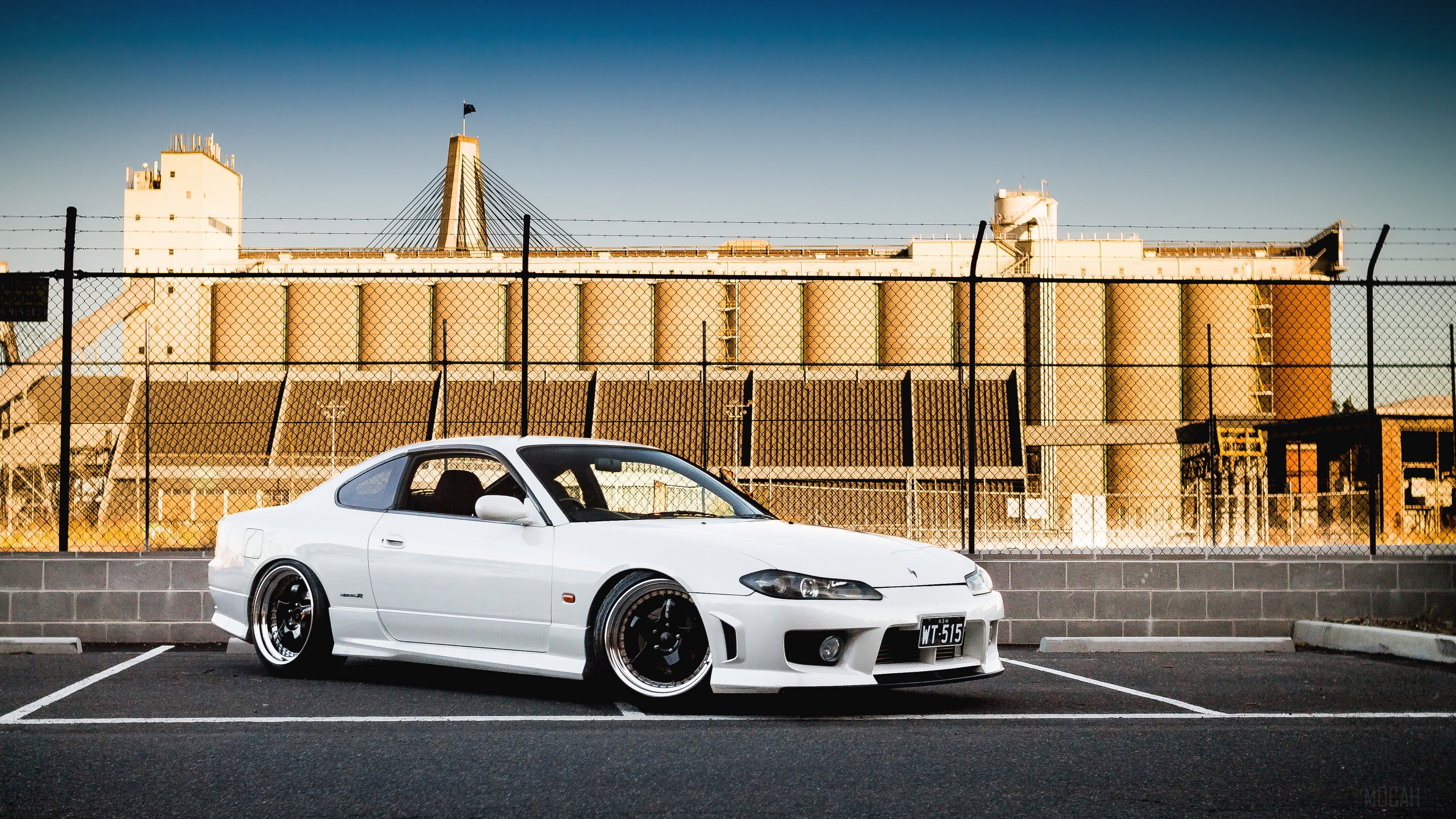White Nissan Silvia S15 parked in front of industrial silos HD Wallpaper