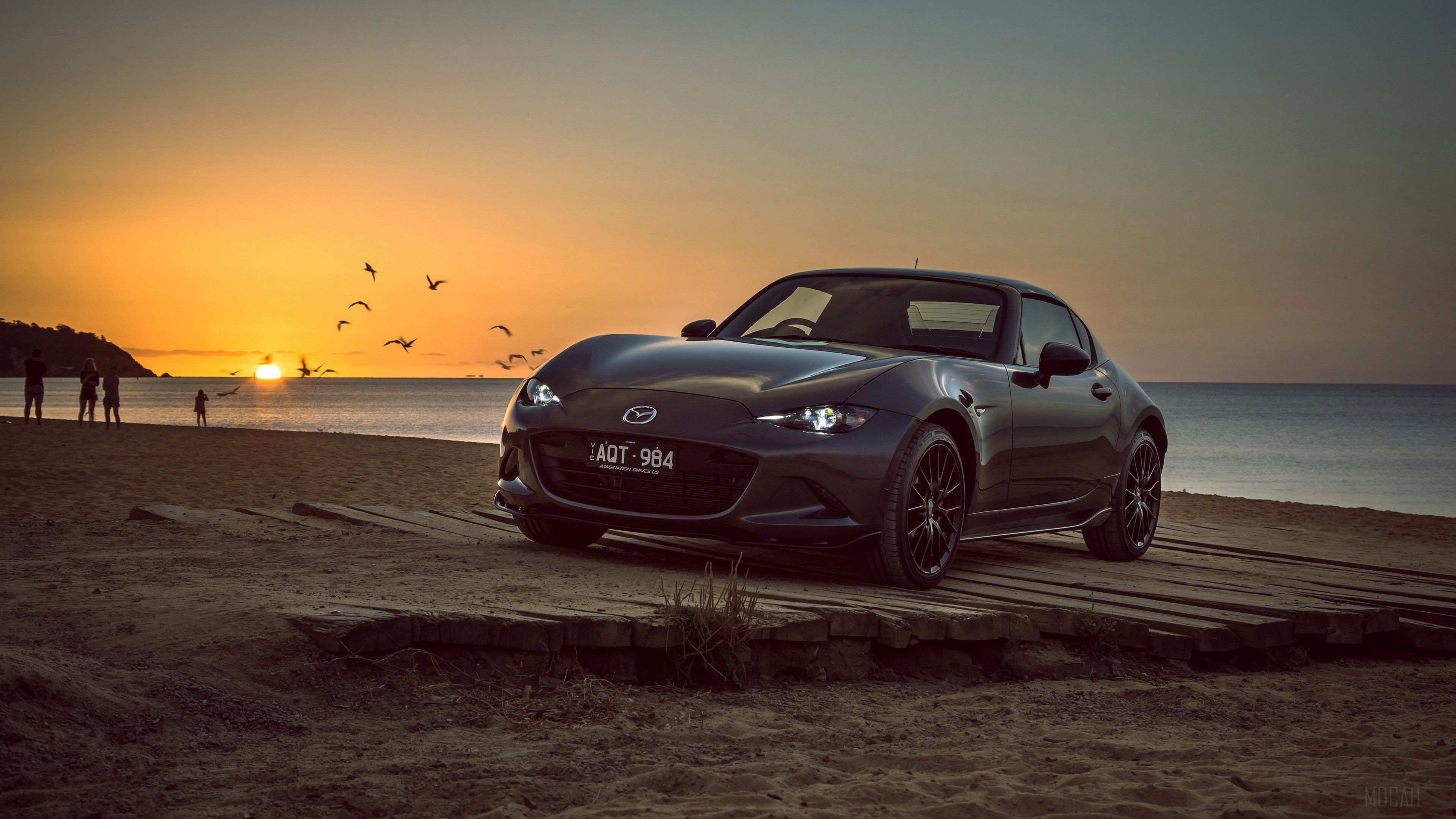 Mazda MX-5 sportscar on a beach at sunrise HD Wallpaper