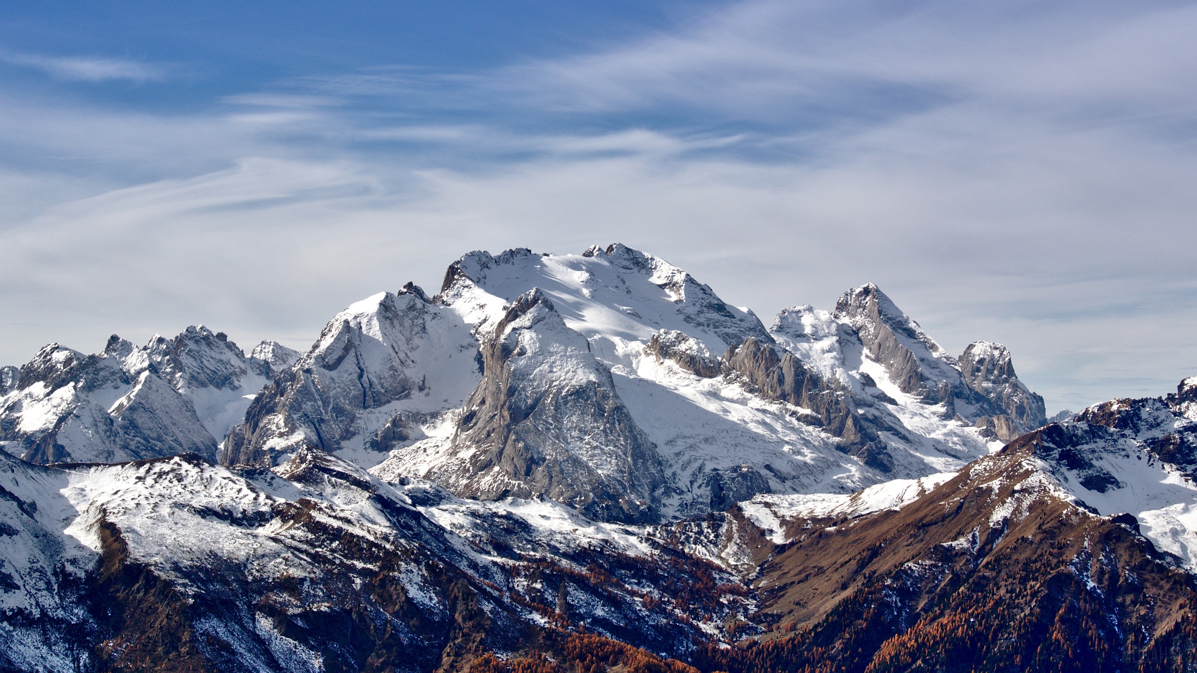 Snow-capped mountains under a blue sky with clouds HD Wallpaper