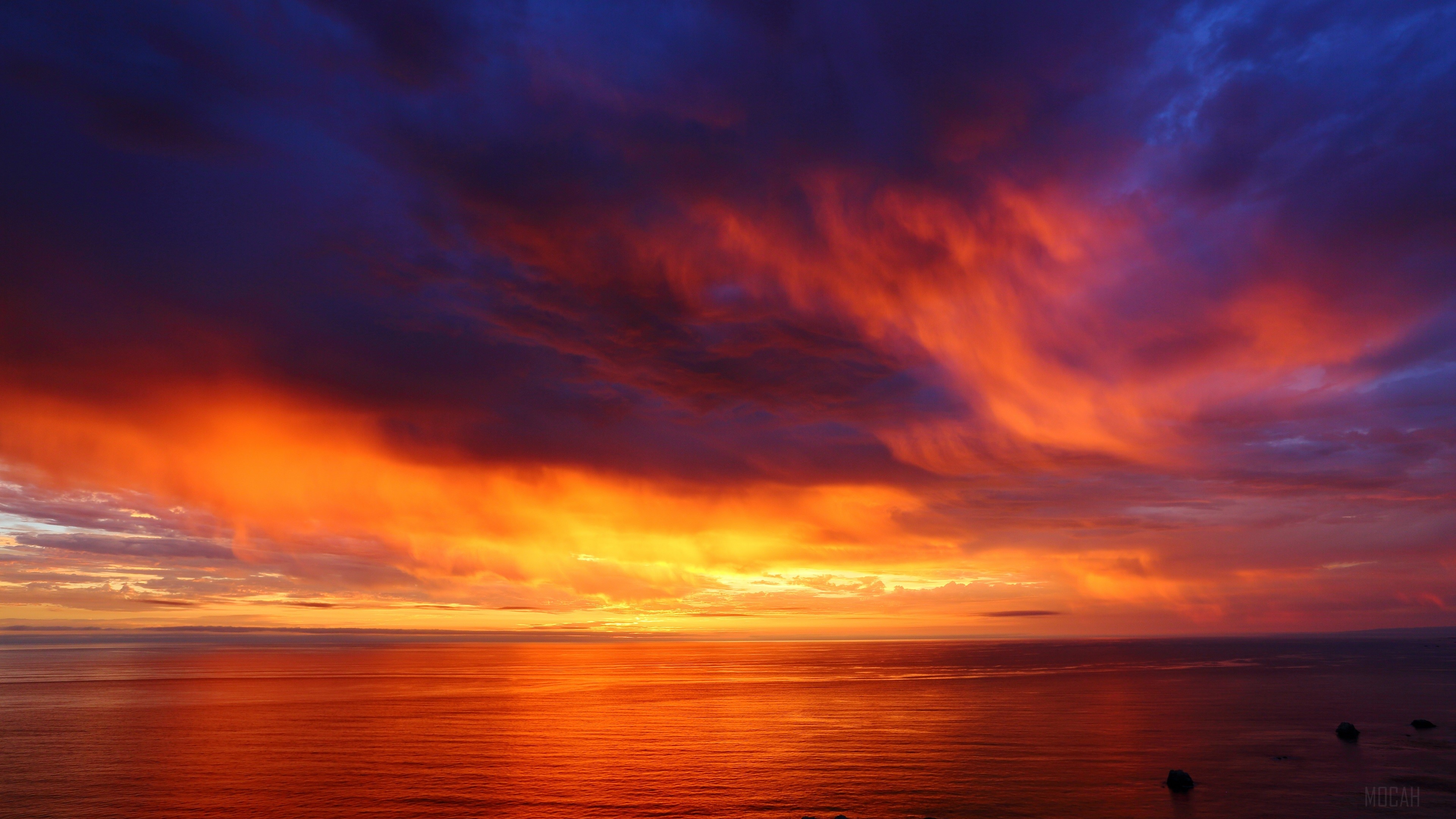 Vibrant Orange Sunset Over Calm Ocean 4K HD Wallpaper