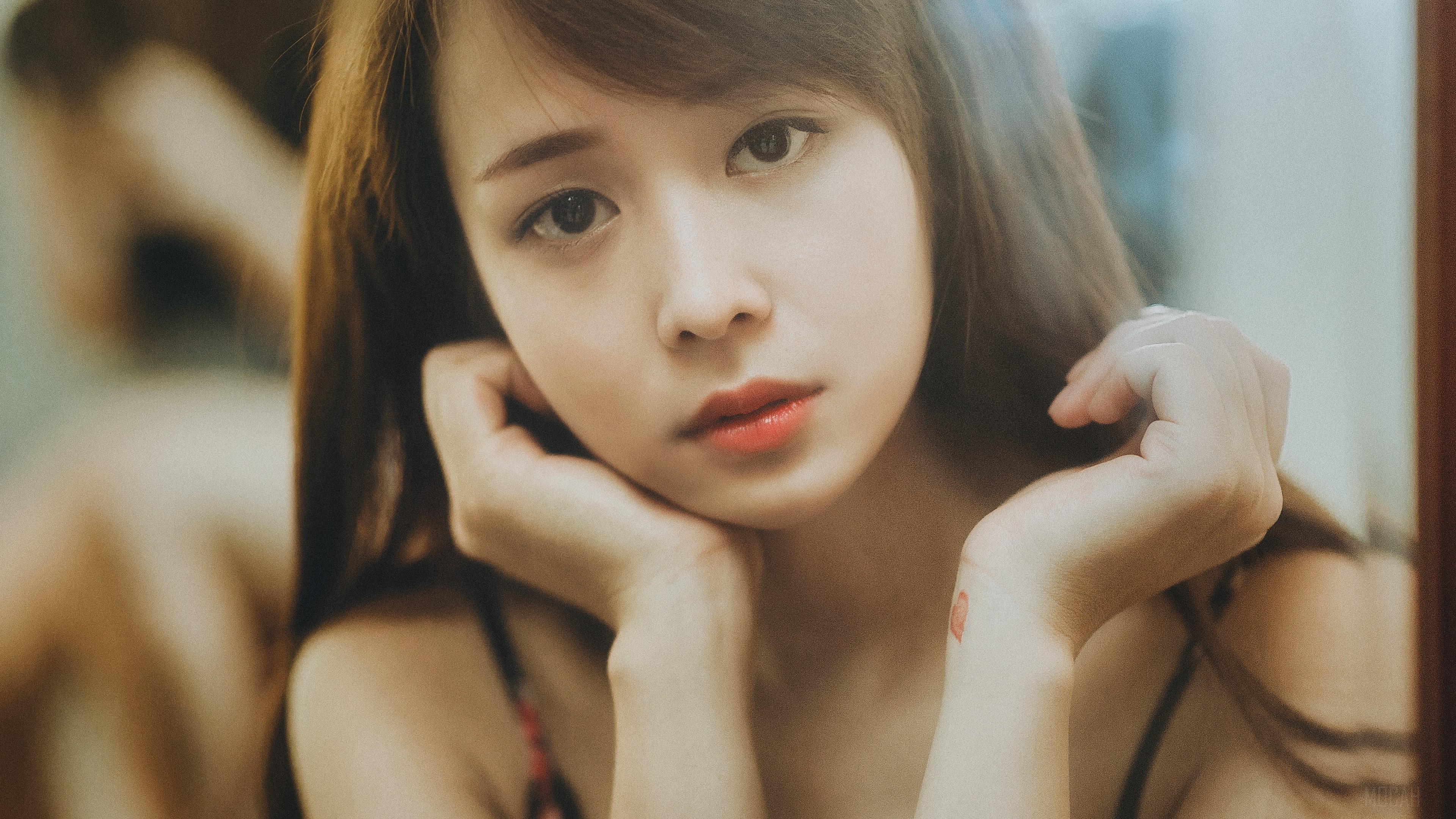 Young woman with hands on her face HD Wallpaper