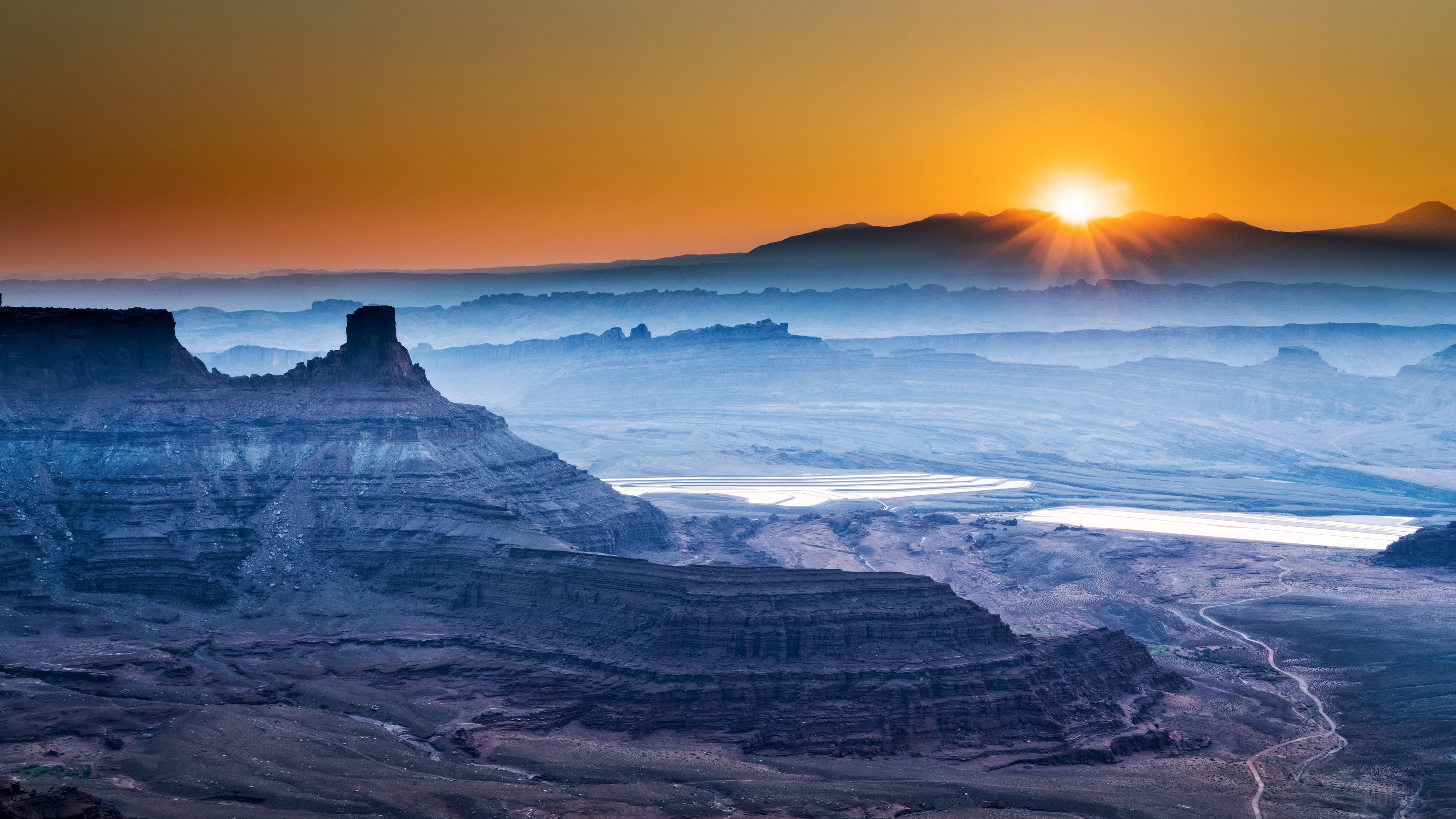 Sunrise over layered mountains and canyons HD Wallpaper