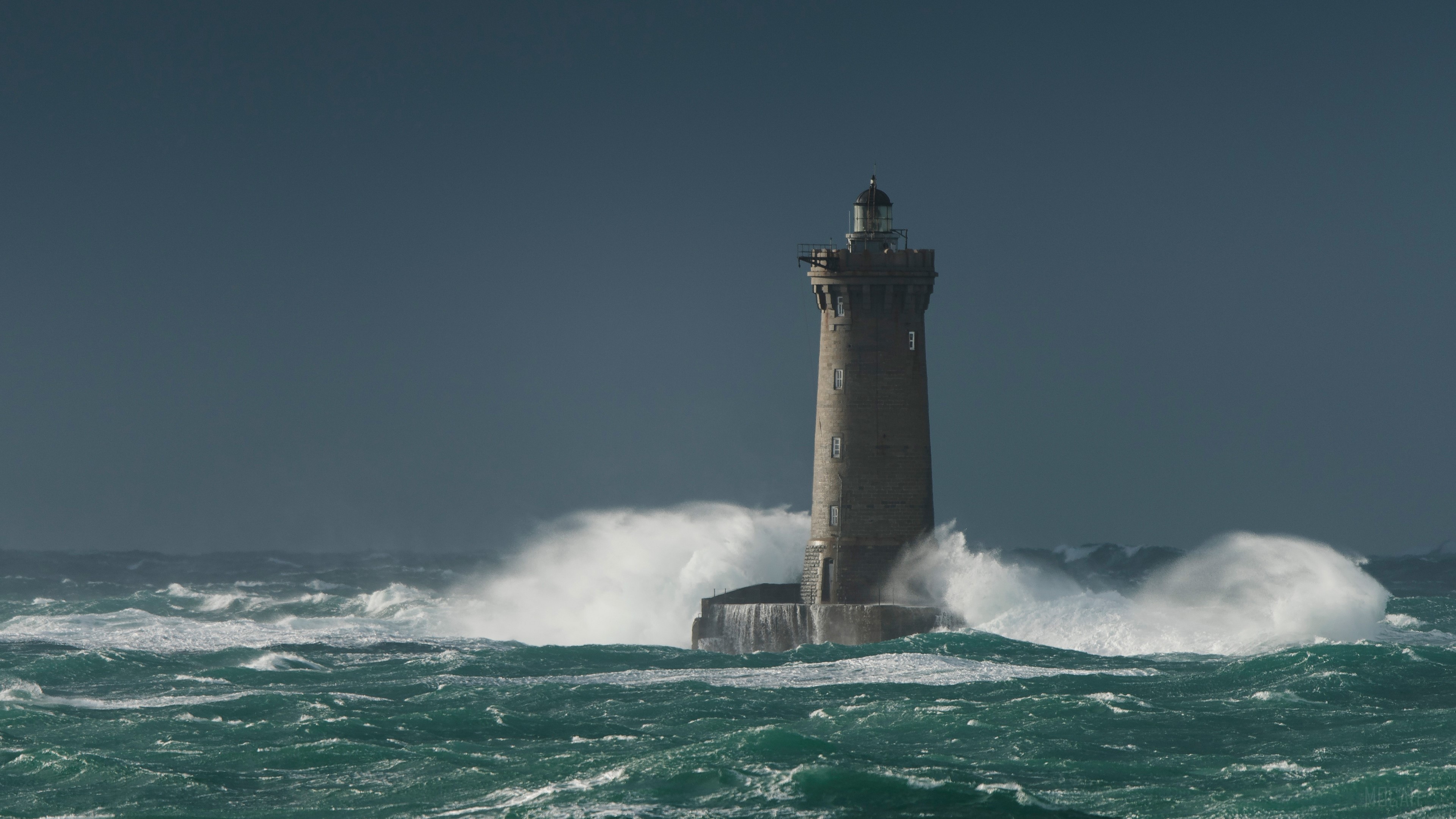 Lighthouse Standing Strong Amid Rough Ocean Waves 4k HD Wallpaper