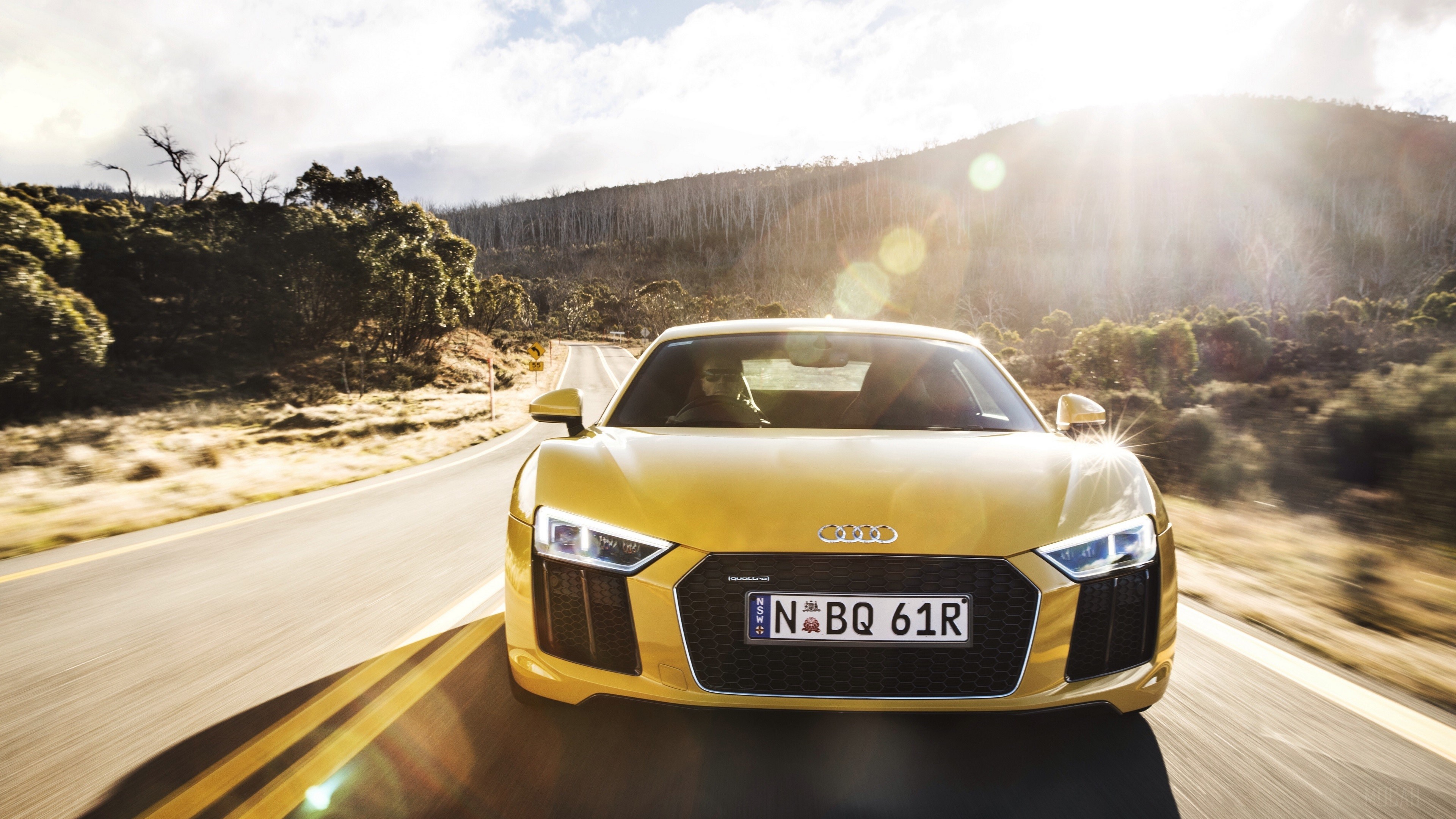 Yellow Audi R8 V10 driving on a mountain road HD Wallpaper