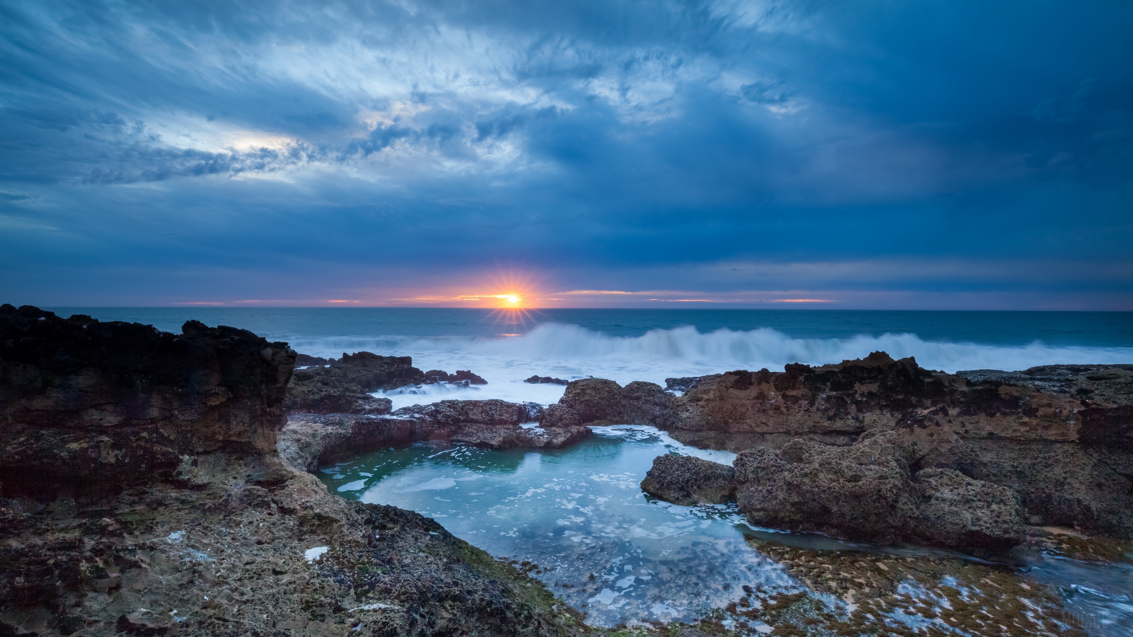 Sunset over rocky coast with ocean waves HD Wallpaper