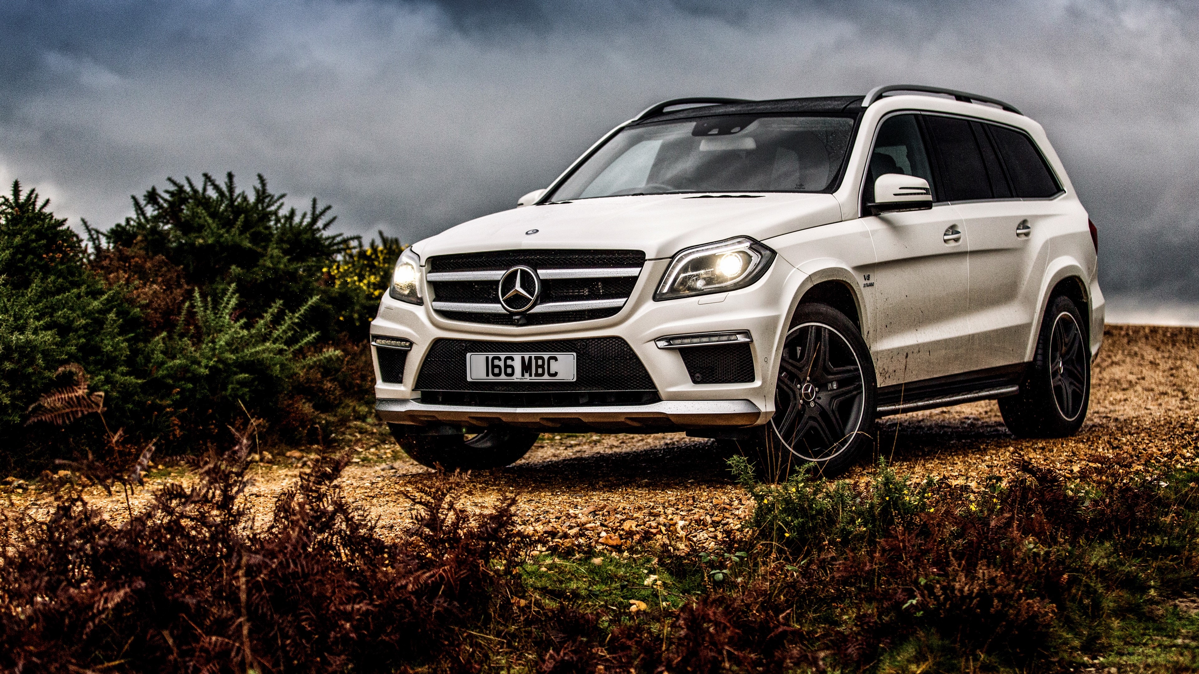 White Mercedes-Benz GL-Class SUV on a dirt road HD Wallpaper