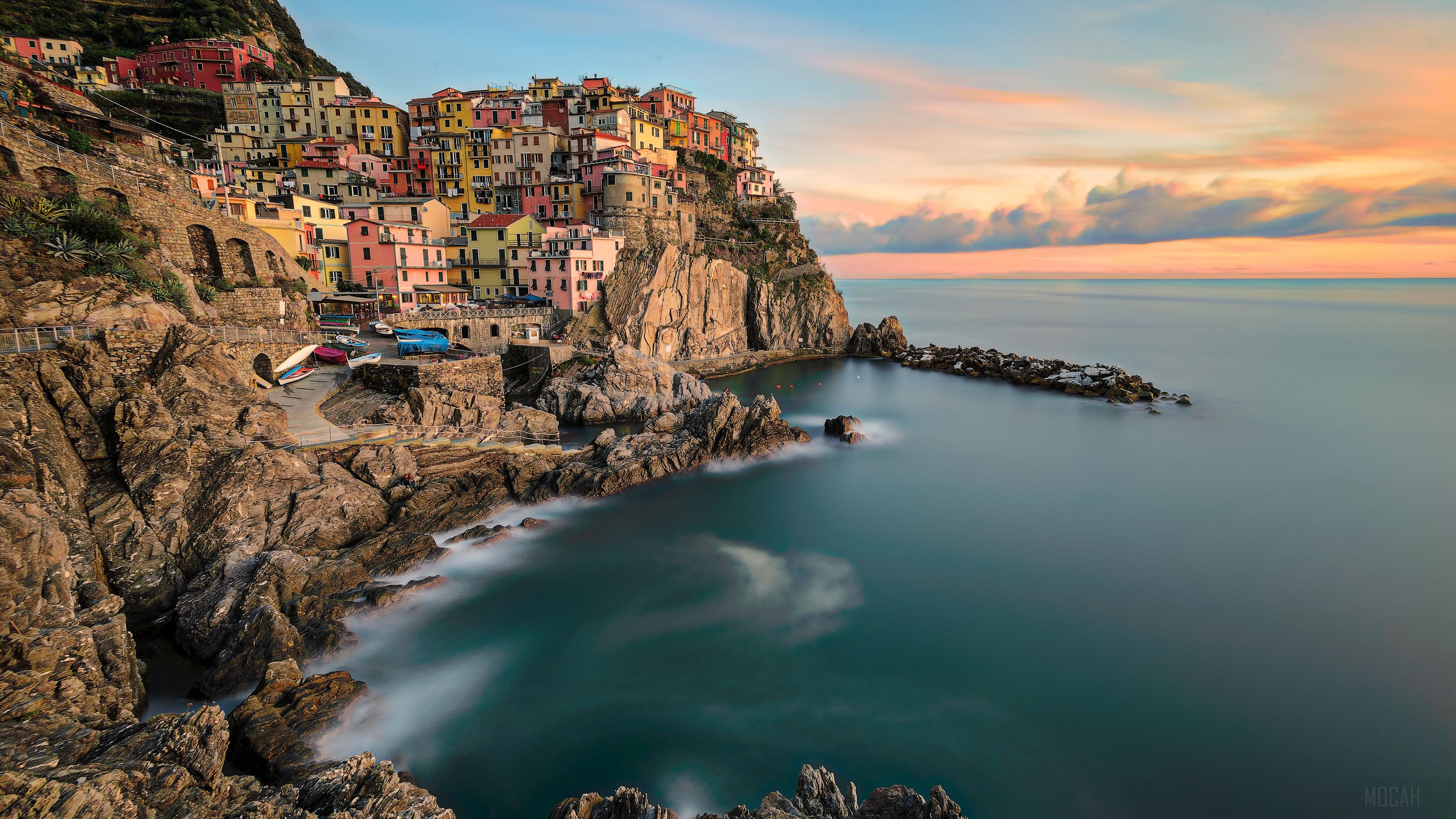 Colorful village on a cliff overlooking the sea at sunset HD Wallpaper